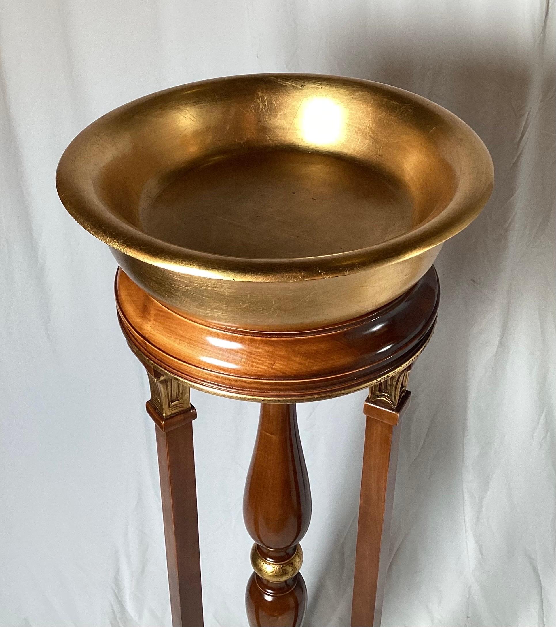 Vintage mahogany plant stand with gold accents. Stands 49 1/2