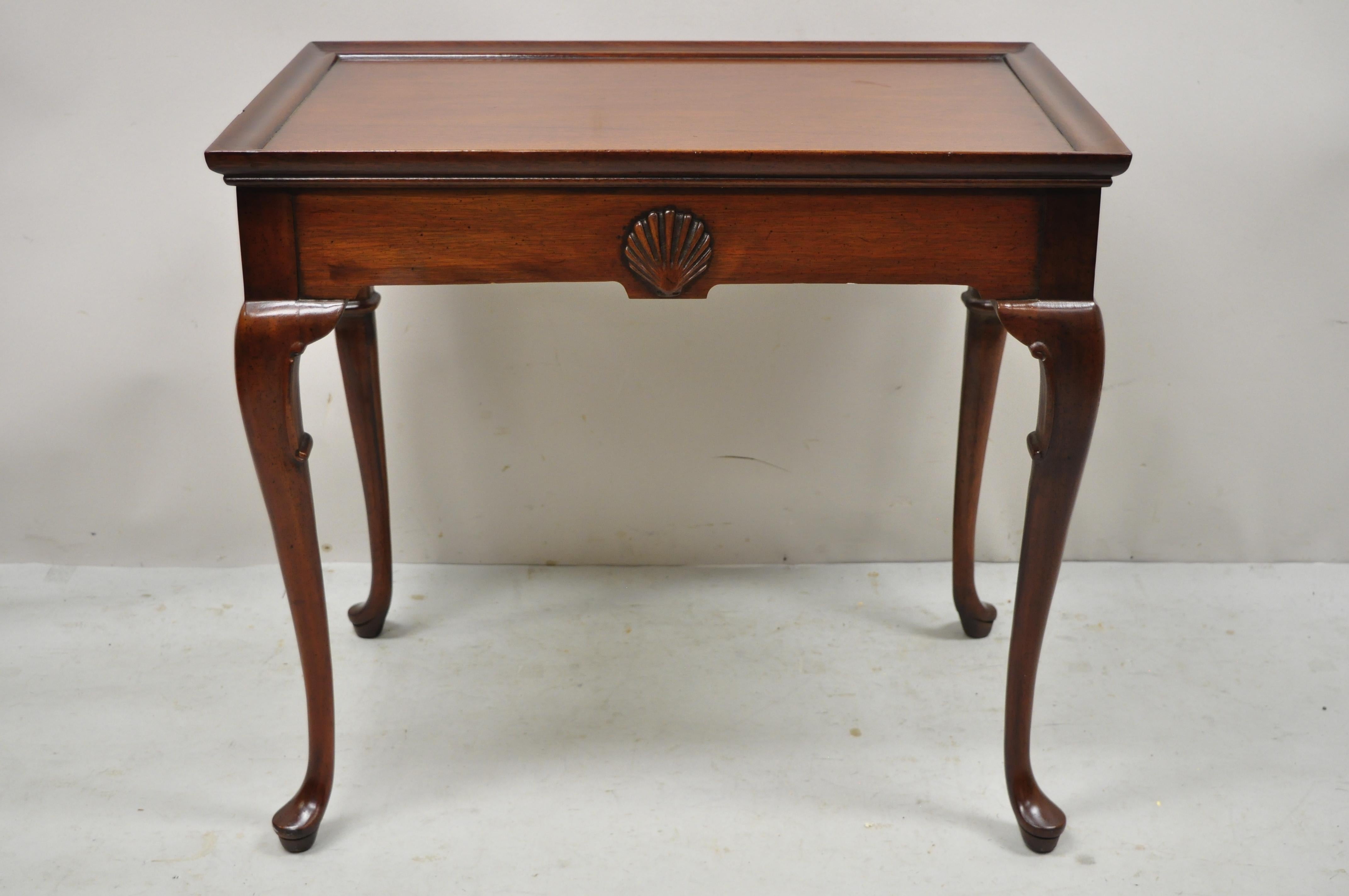 Vintage mahogany Queen Anne style shell carved side tea table with pull out sides. Item features slender Queen Anne style legs, 2 pull out surfaces, shell carved skirt, solid wood construction, beautiful wood grain, quality American craftsmanship,
