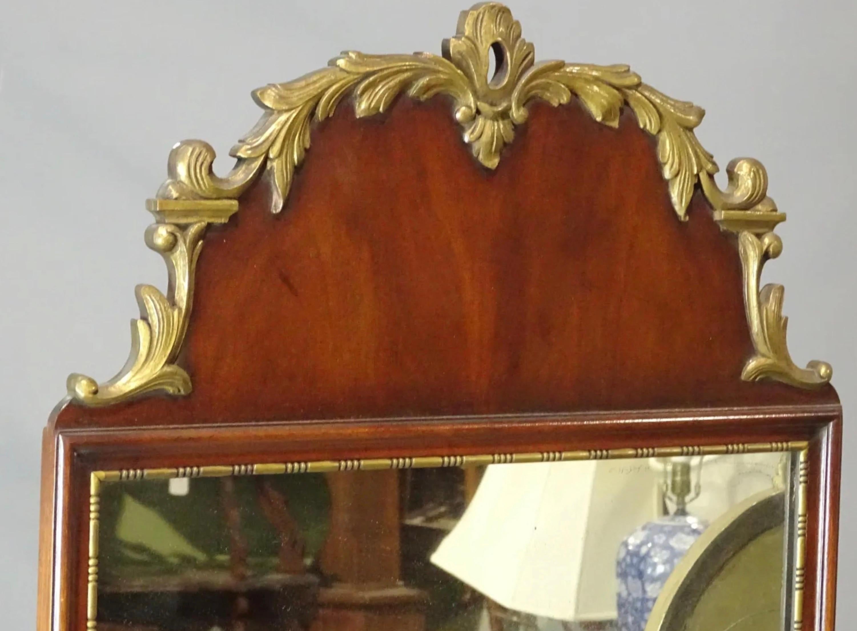 Vintage mahogany Queen Anne style mirror with carved, gilded decoration at the top and beaded gilt trim around the mirror. 
Search terms: Regency style mirror, Georgian Style mirror, 
Mantel mirrors and fireplace mirrors.
Pier mirrors and console