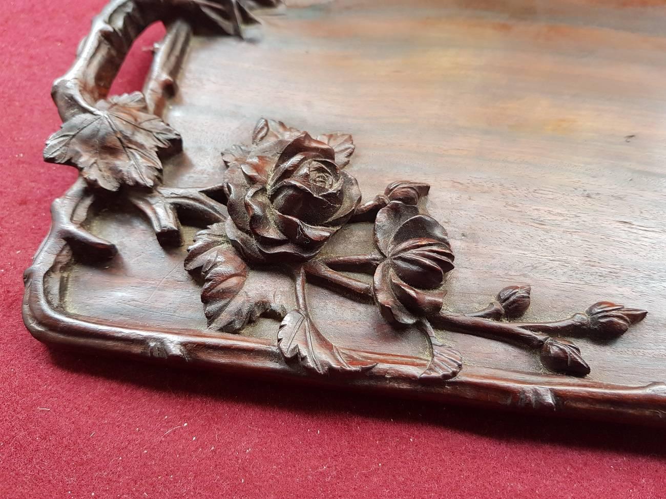 Vintage mahogany serving tray decorated with carving in the form of leaves, flowers and branches, mid-20th century.

The measurements are,
Depth 20 cm/ 7.8 inch.
Width 34 cm/ 13.3 inch.
Height 2.5 cm/ 0.9 inch.
 