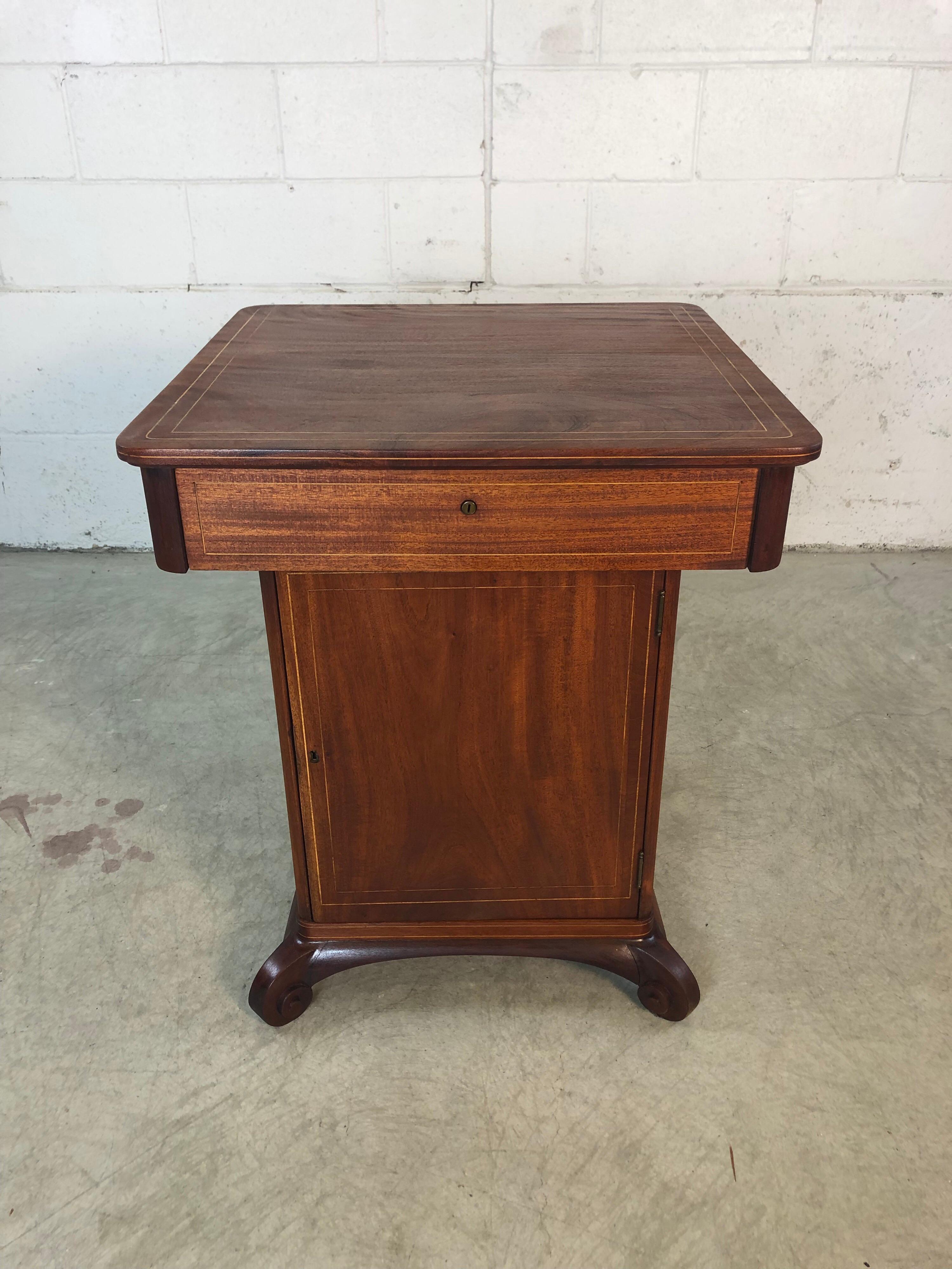Vintage 1930s mahogany smoking humidor table with light maple wood inlay. The feet are hand carved. The stand has a drawer for storage and is able to hold all of the smoking accessories in the center holder. The stand is newly refinished and in