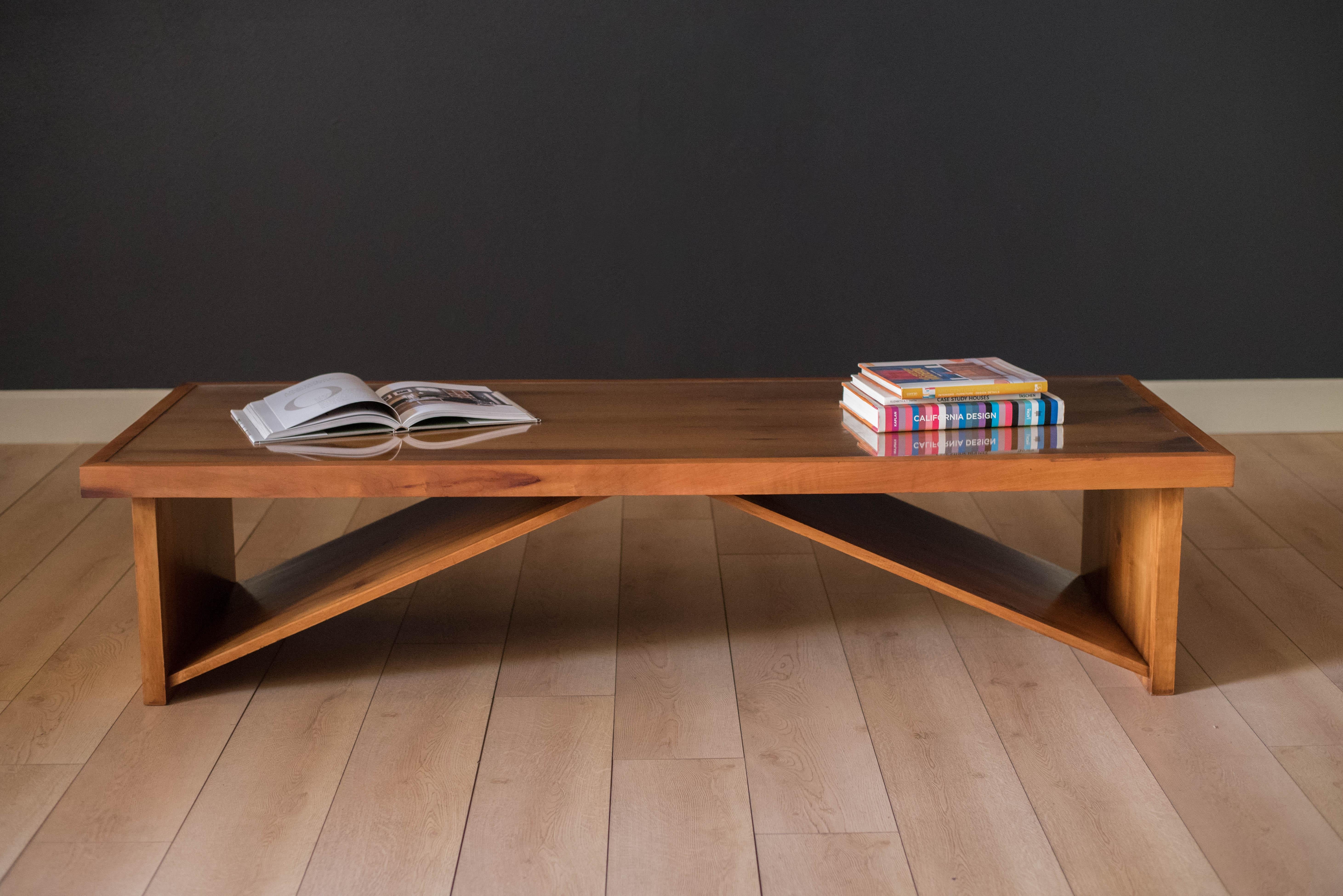 American studio made display bench or coffee table, circa 1970s. This piece includes a glass top insert and is made out of mahogany.
