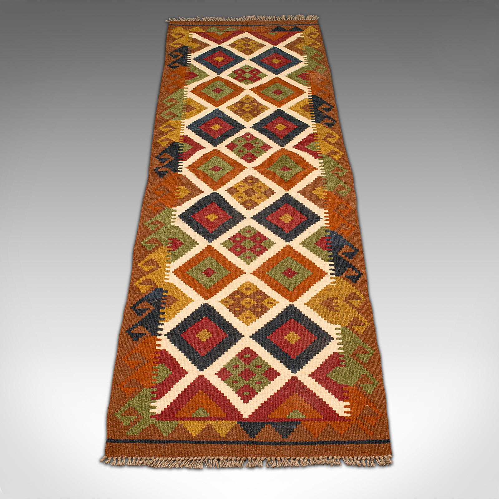 This is a vintage Maimana Kilim hall runner. A Caucasian, decorative hallway carpet or rug, dating to the late 20th century, circa 1990.

Usefully sized runner at 61cm (24'') x 200cm (78.75'')
Displaying a desirable aged patina and in good