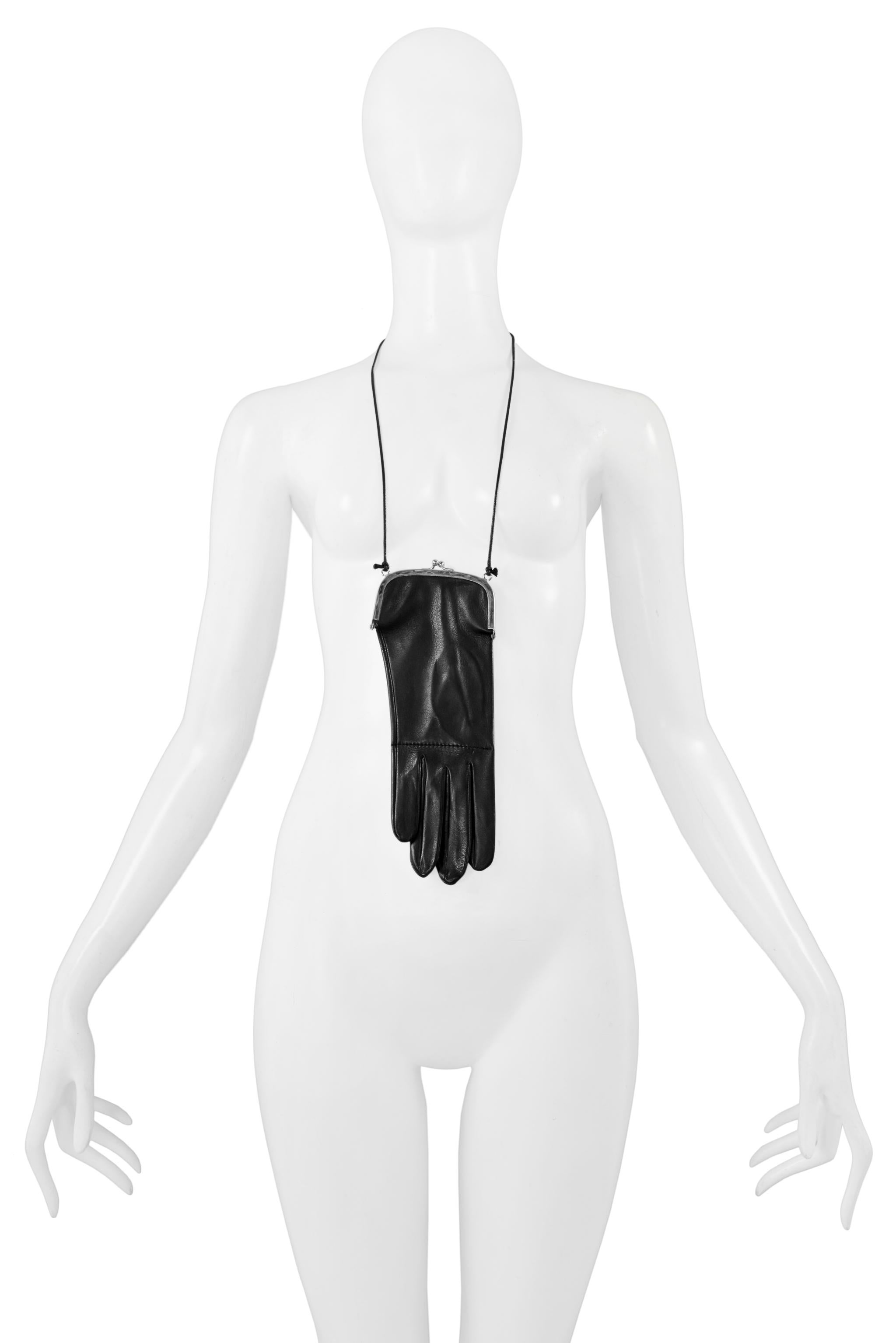 Resurrection Vintage is excited to offer a very rare vintage Maison Martin Margiela black leather glove that has been modified into a purse featuring a silver-tone metal frame and clasp. An attached black leather cord is fastened to each side so the