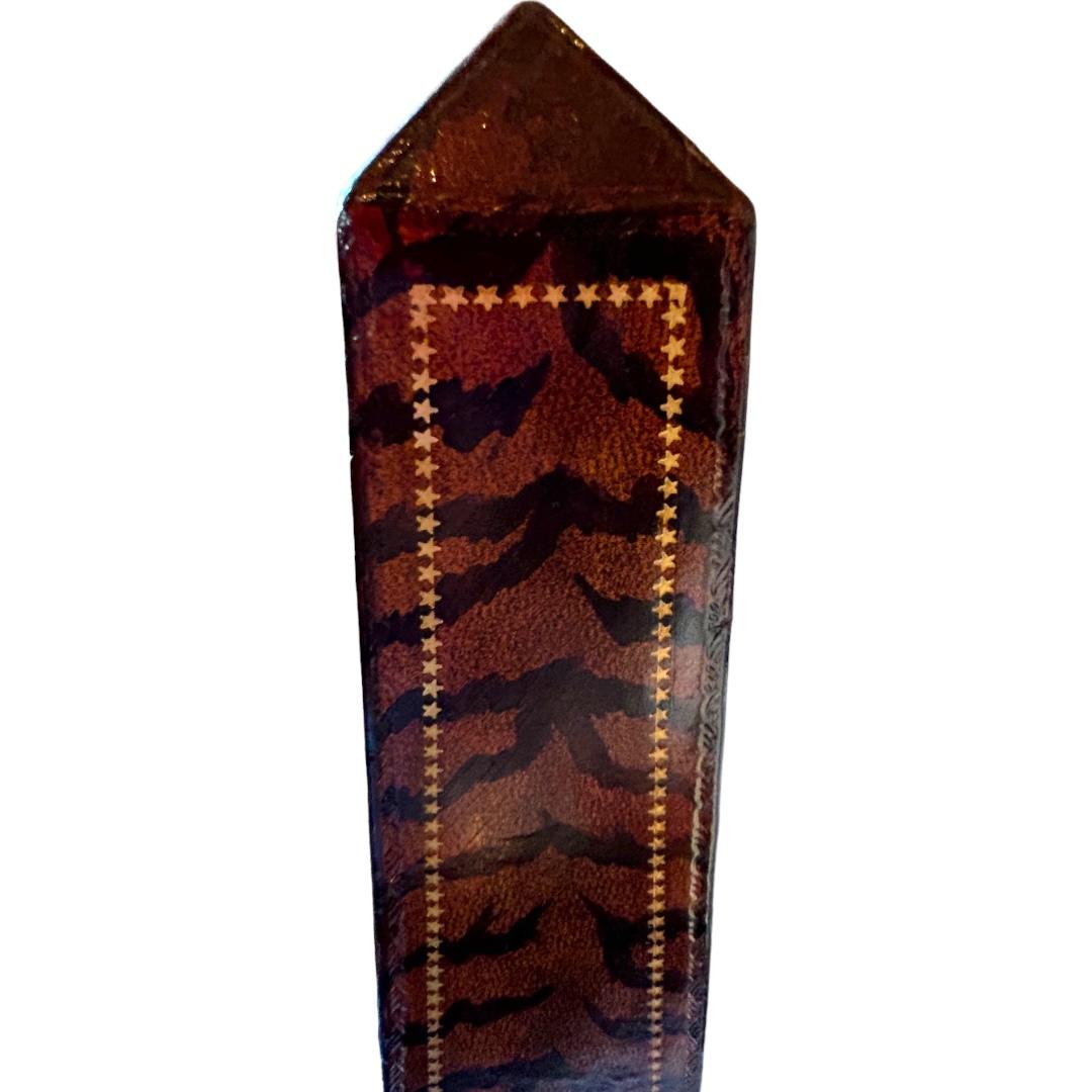 This vintage Maitland Smith classic obelisk is a stunning piece that will add an elegant touch to any room.  The tooled leather pattern in a rich brown color makes it a perfect fit for any occasion and all types of decor.  Made from high-quality