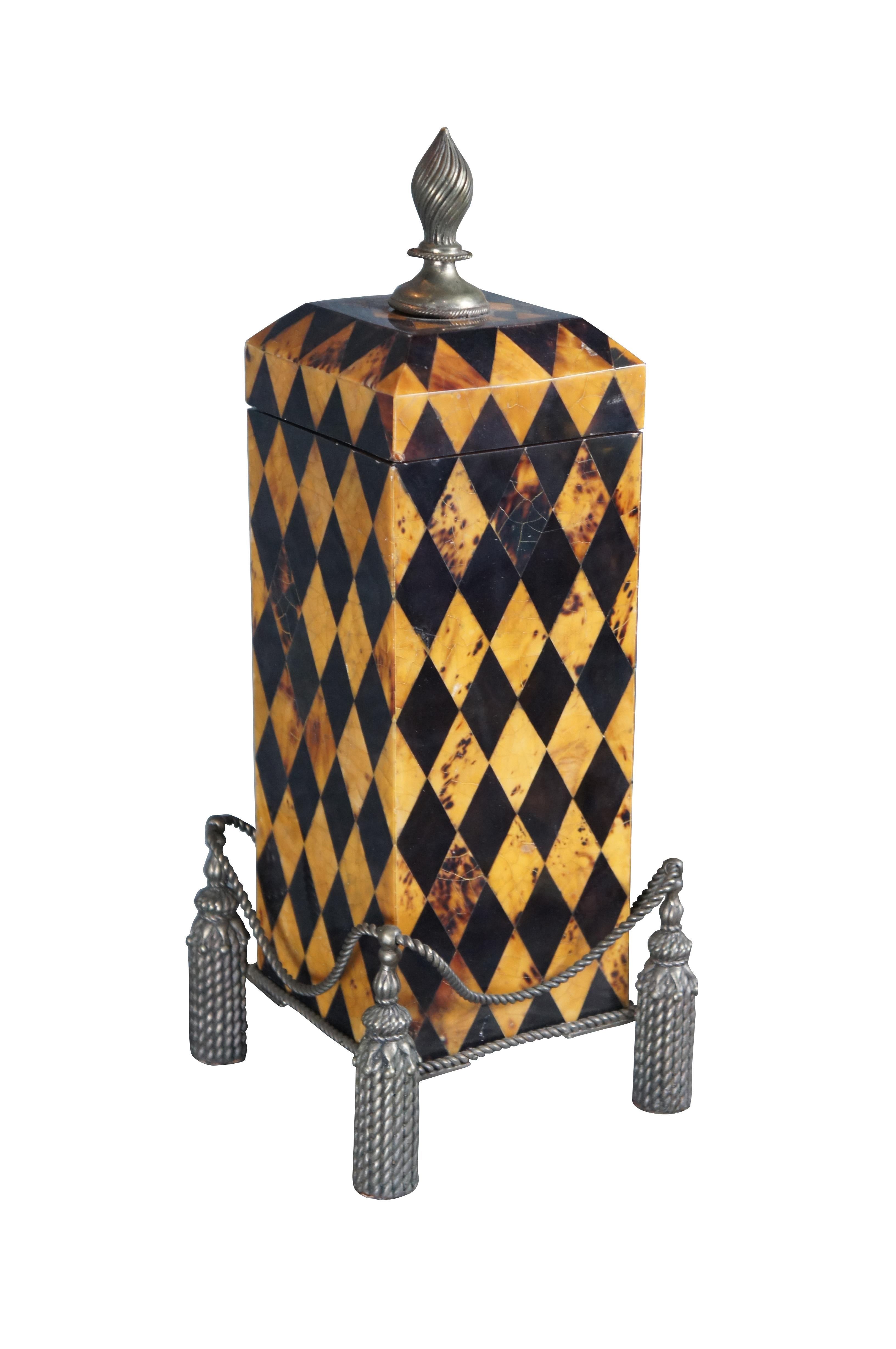 Late 20th Century Maitland Smith Lidded Box / Urn. Features a beautiful Harlequin pattern Penshell exterior resting on a footed brass neoclassical style tasseled base. The lid opens via a trophy shaped finial to a velvet lined