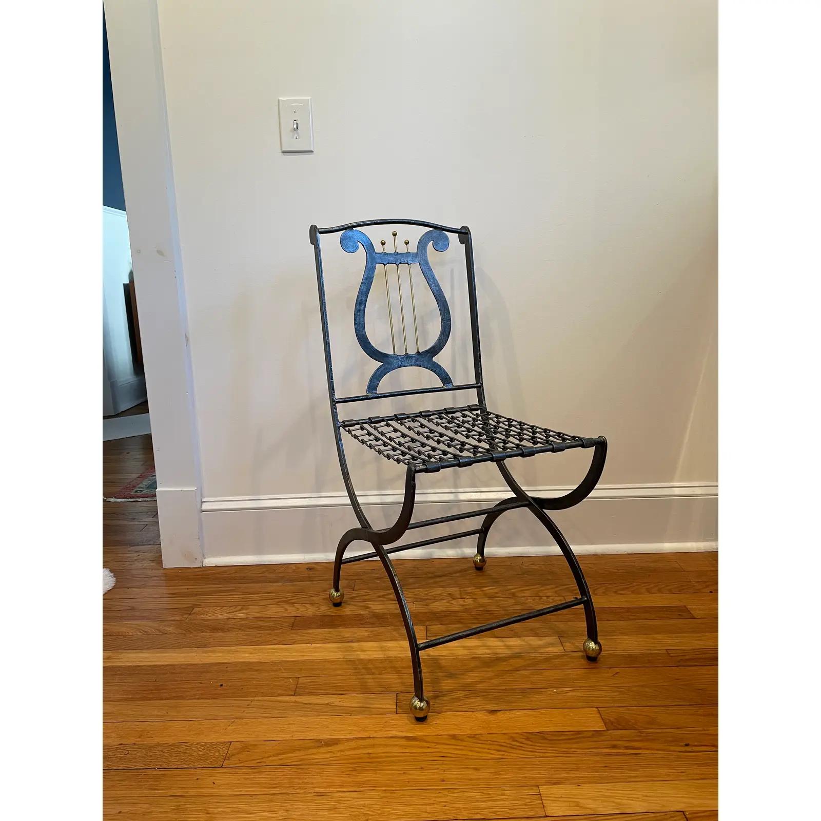 Unique Maitland Smith Folding Iron Chair with Lyre Back Motif. Chain link seat webbing. Capped off with brass ball feet and Lyre accent.
Curbside to NYC/Philly $400