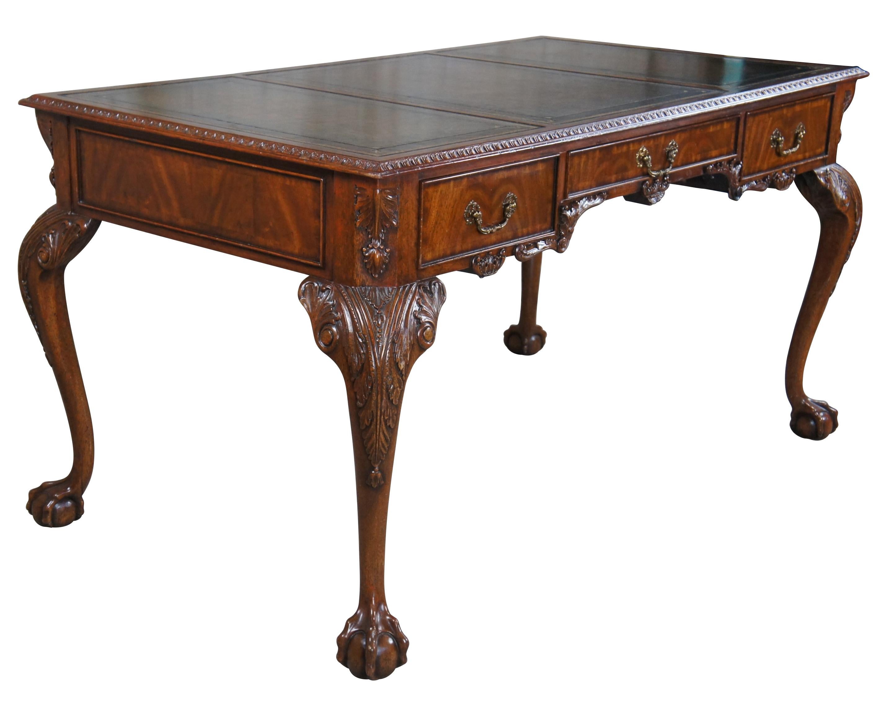 Chippendale style library or office desk by Maitland Smith. Made from mahogany with intricately carved details including high relief acanthus legs leading to ball and claw feet. Features a three panel green / brown and gold tooled leather top with