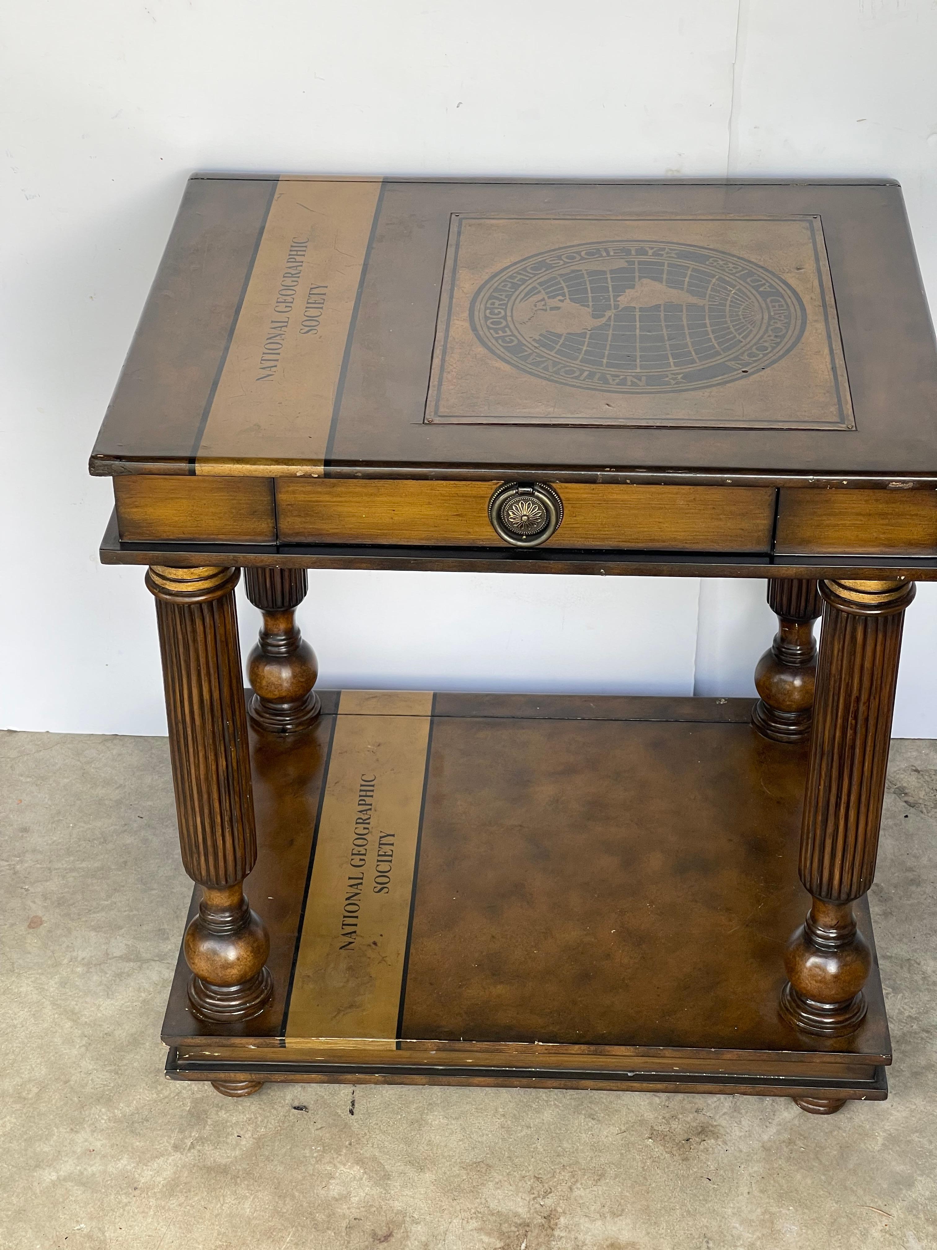 Vintage Maitland Smith National Geographic library table. On 4 pillar legs , with one drawer.