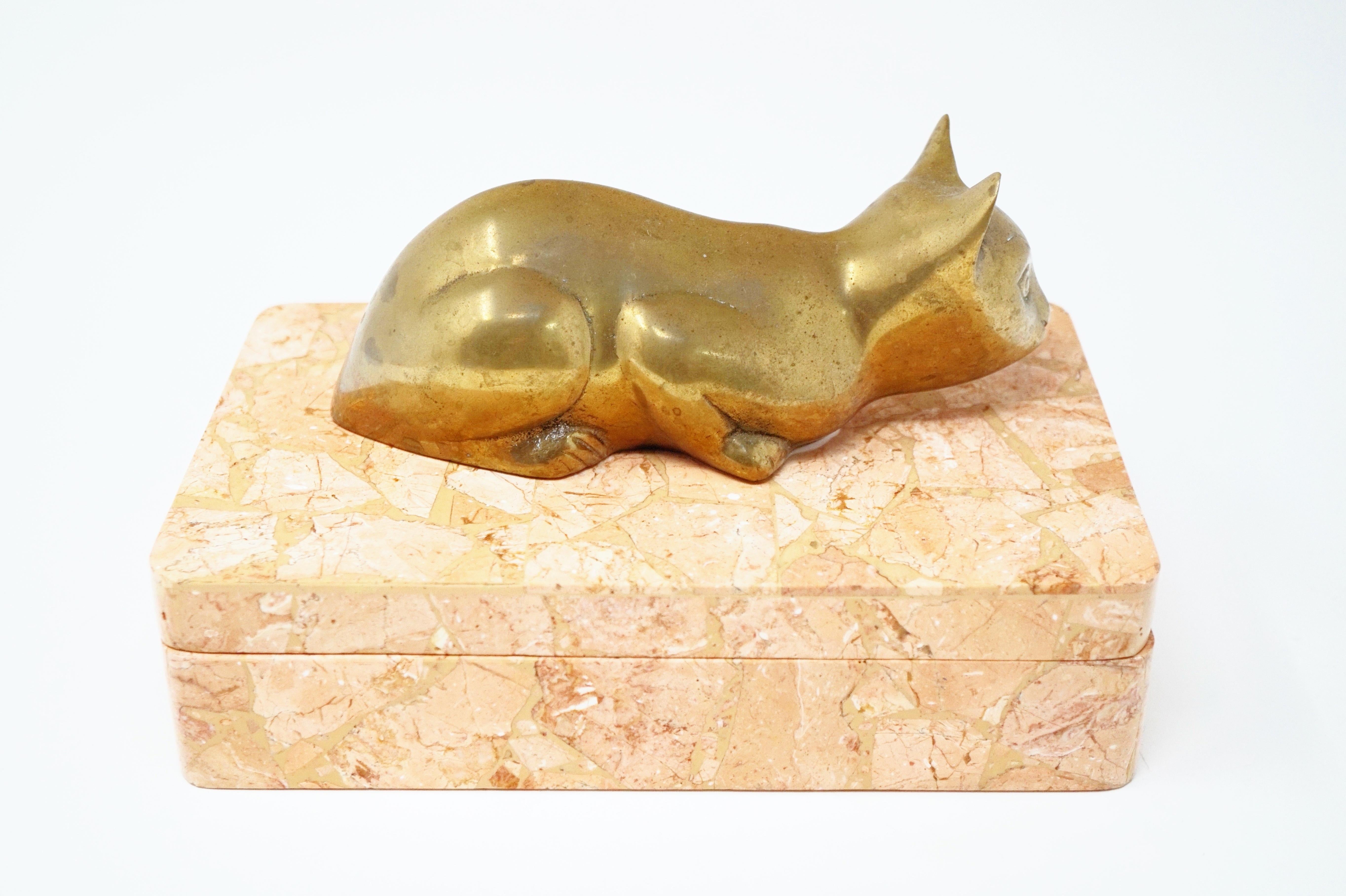 - Velvet lined
- Tessellated pink stone
- Brass cat handle
- This item was used as a TV prop and has a small 