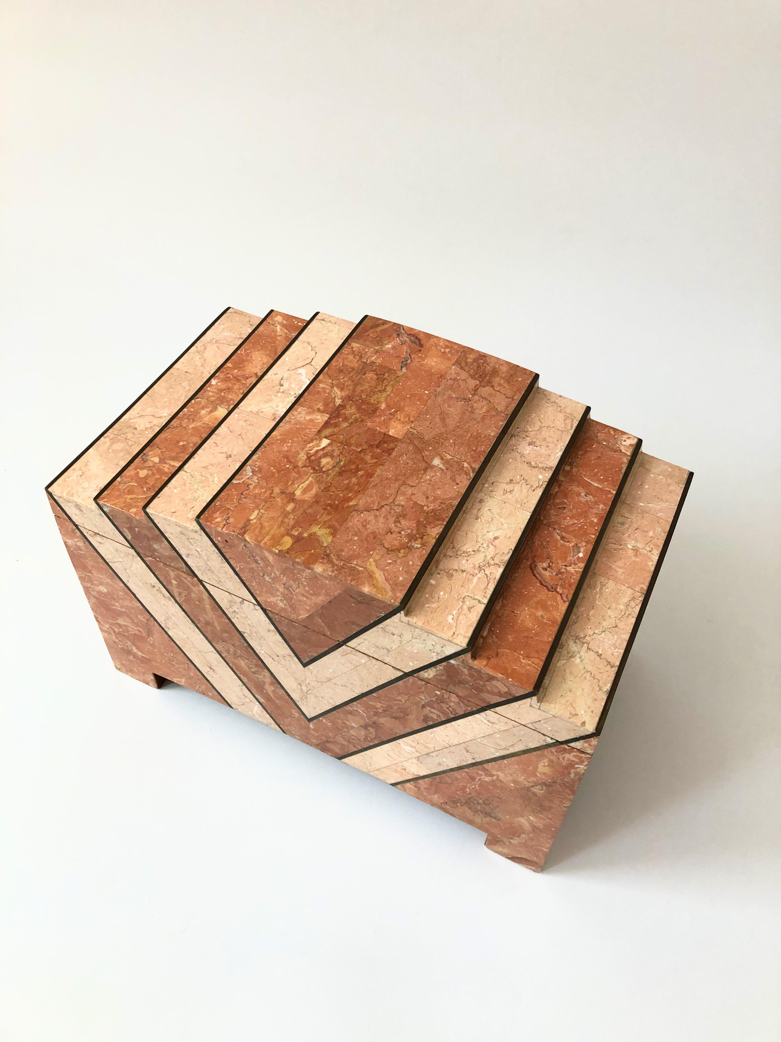 A vintage tessellated stone box made by Maitland Smith in the 1970s. Features two toned tessellated pink stone separated by inlaid brass strips. The interior is lined in velvet. Nice versatile larger size, perfect for displaying as a floor piece or