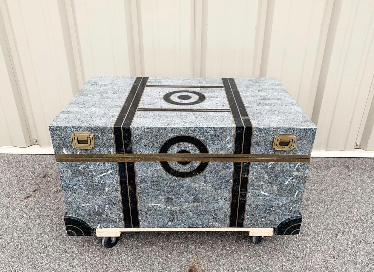 A beautiful tessellated grey and black marble chest with brass inlay. Fully lined in black velvet. Design attributed to Robert Marcius for Maitland Smith. This trunk is a work of art and would be a great postmodern addition to your home. It is in