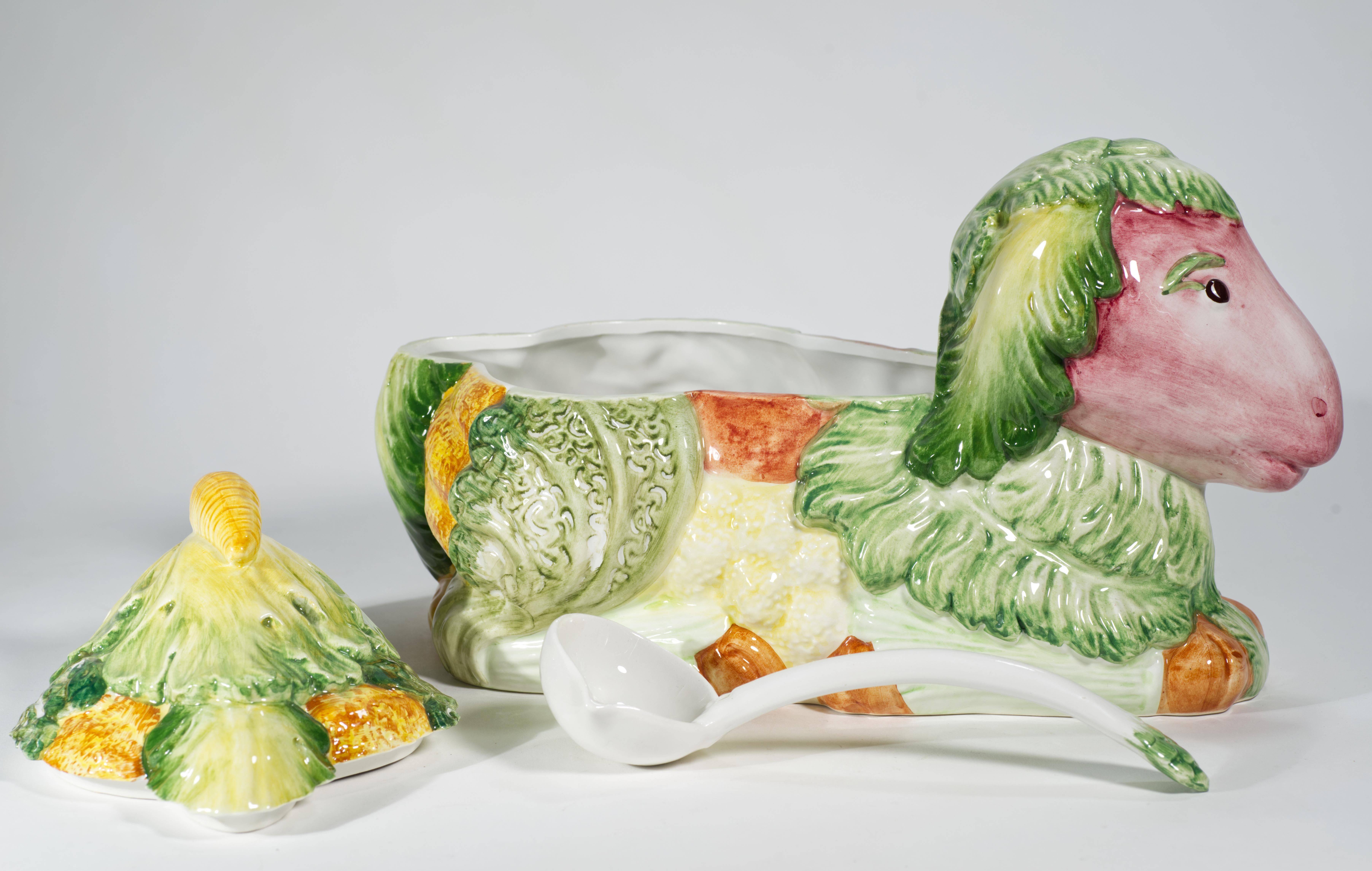 La grande zuppiera in maiolica italiana vintage viene fornita in un set di tre pezzi con ciotola, coperchio e mestolo. La ciotola e il coperchio, delicati e simili a porcellana, hanno la forma di un agnello avvolto in cavoli e altre verdure; un lato