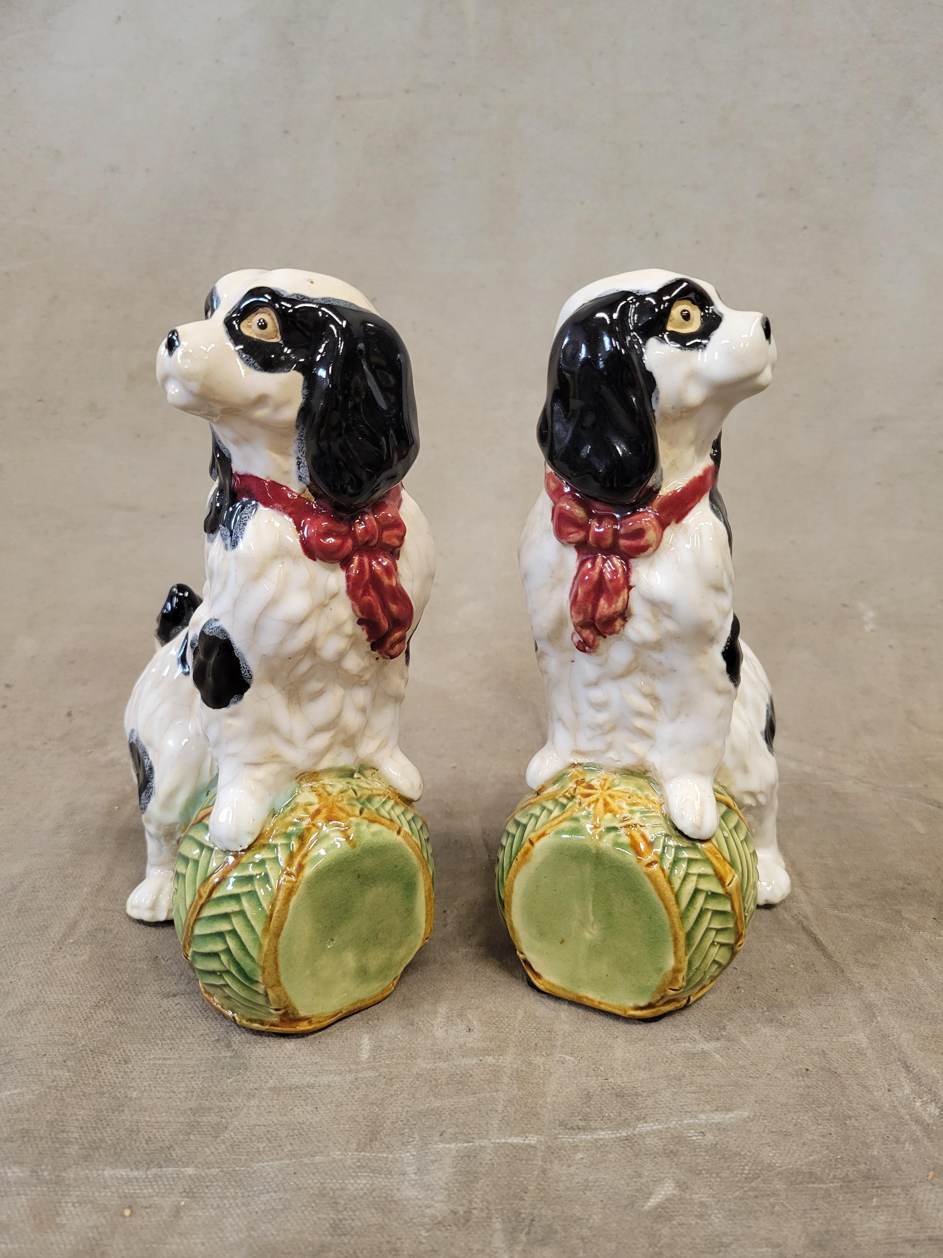 A charming pair of vintage majolica Staffordshire Cavalier King Charles Spaniel Bookends. The black and white dogs with a red collars rest their paws on green and yellow bamboo balls. A colorful and sweet accent for any dog lover.
Condition