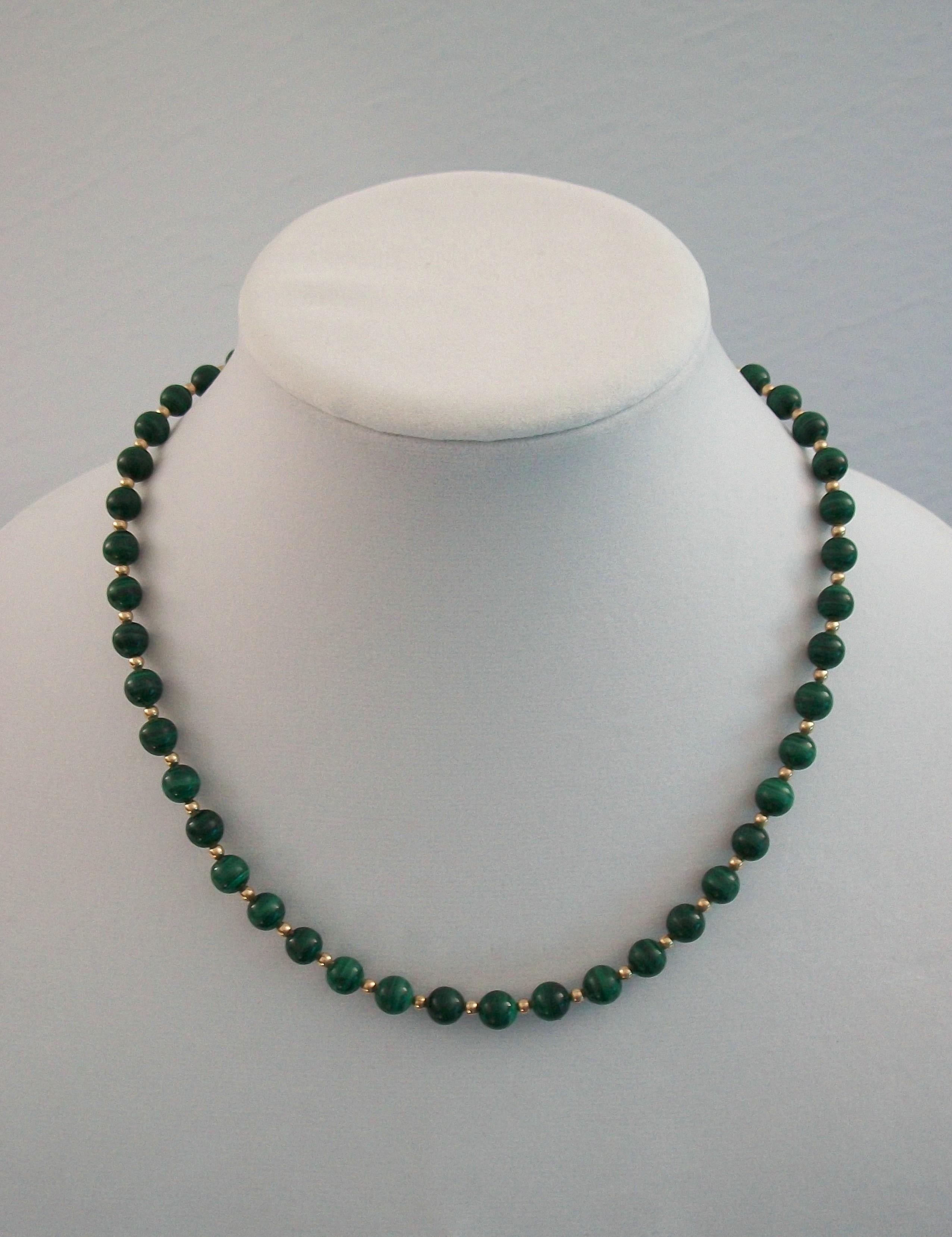 
Fine vintage malachite and 14K yellow gold beaded necklace - featuring 47 round polished malachite beads (8 mm. diameter) and 46 gold spacer beads (3 mm. diameter) - original 14K gold clasp with safety catch - no maker's mark - stamped 585 on the