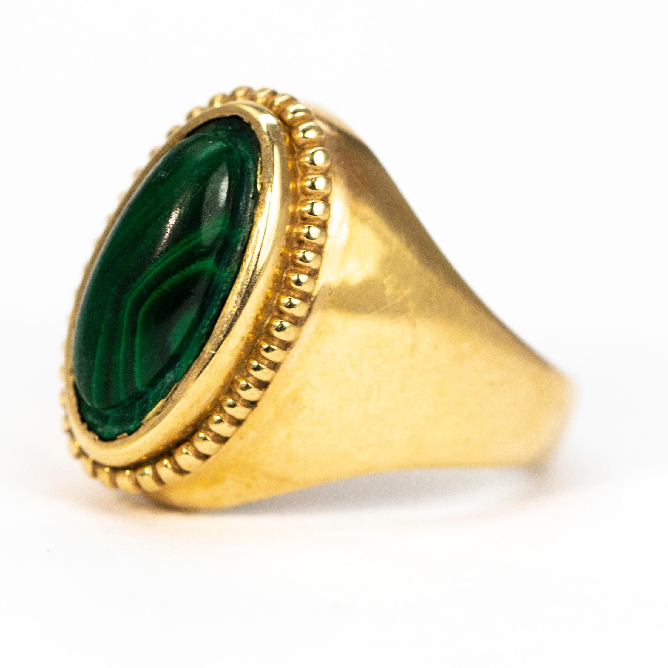 This chunky stylish ring holds a glossy cabochon malachite stone which is set within a beaded setting modelled in 9ct gold. The stone is marbled with all different shades of green and is so pretty.

Ring Size: N 1/2 or 6 3/4
Stone Dimensions: