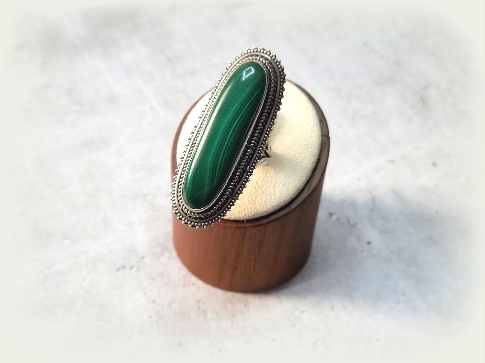 This gorgeous, comfortable ring is made of a high-quality malachite cabochon in a sterling silver set.

The Malachite stone is approximately 40mm long and 10mm across.
The US size of the ring is 8.
The weight of the ring is 20 grams.

1. Dear