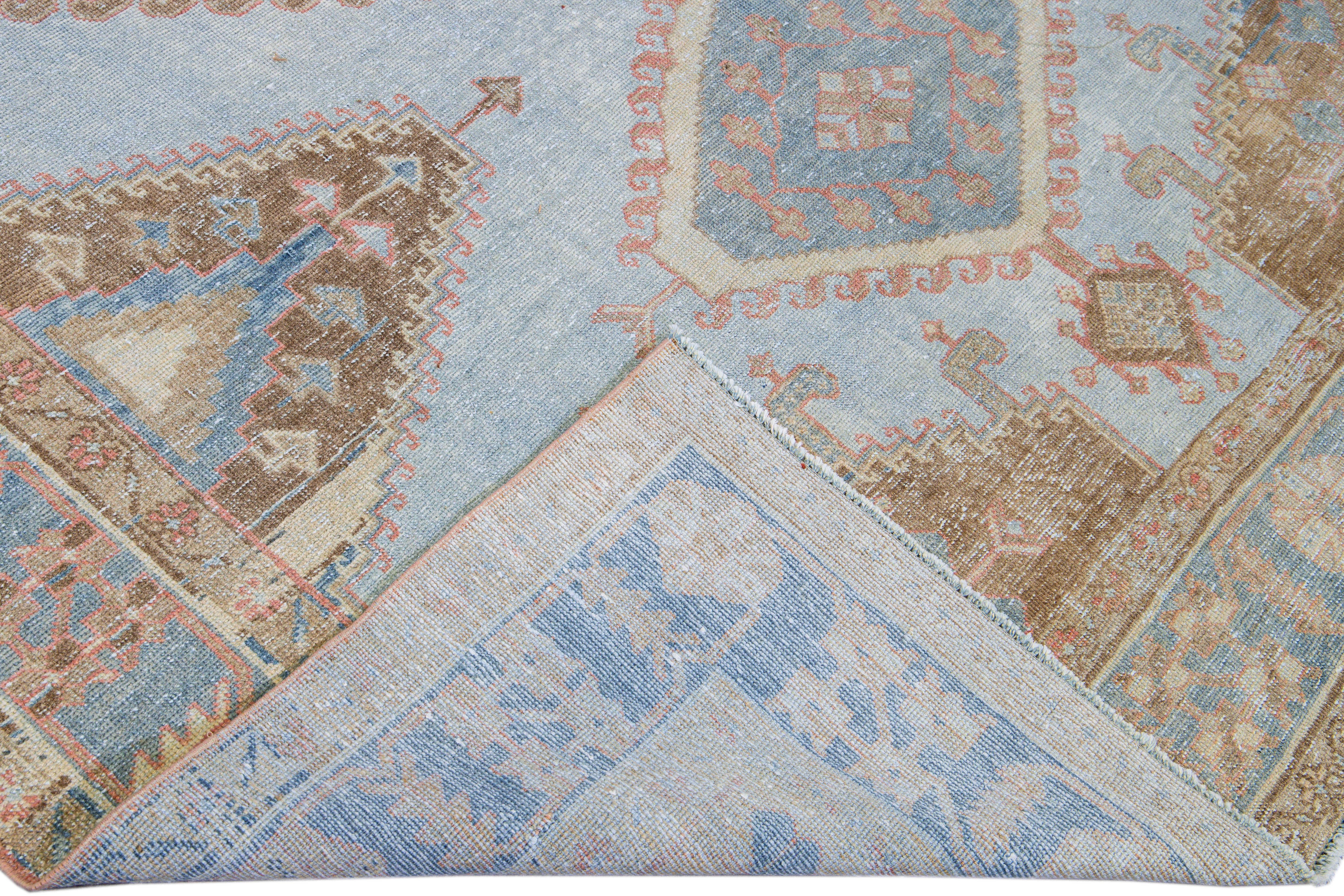 Beautiful vintage Malayer hand-knotted wool rug with a blue field. This Malayer rug has brown and red accents in an all-over gorgeous geometric medallion floral pattern design.

This rug measures: 7'1