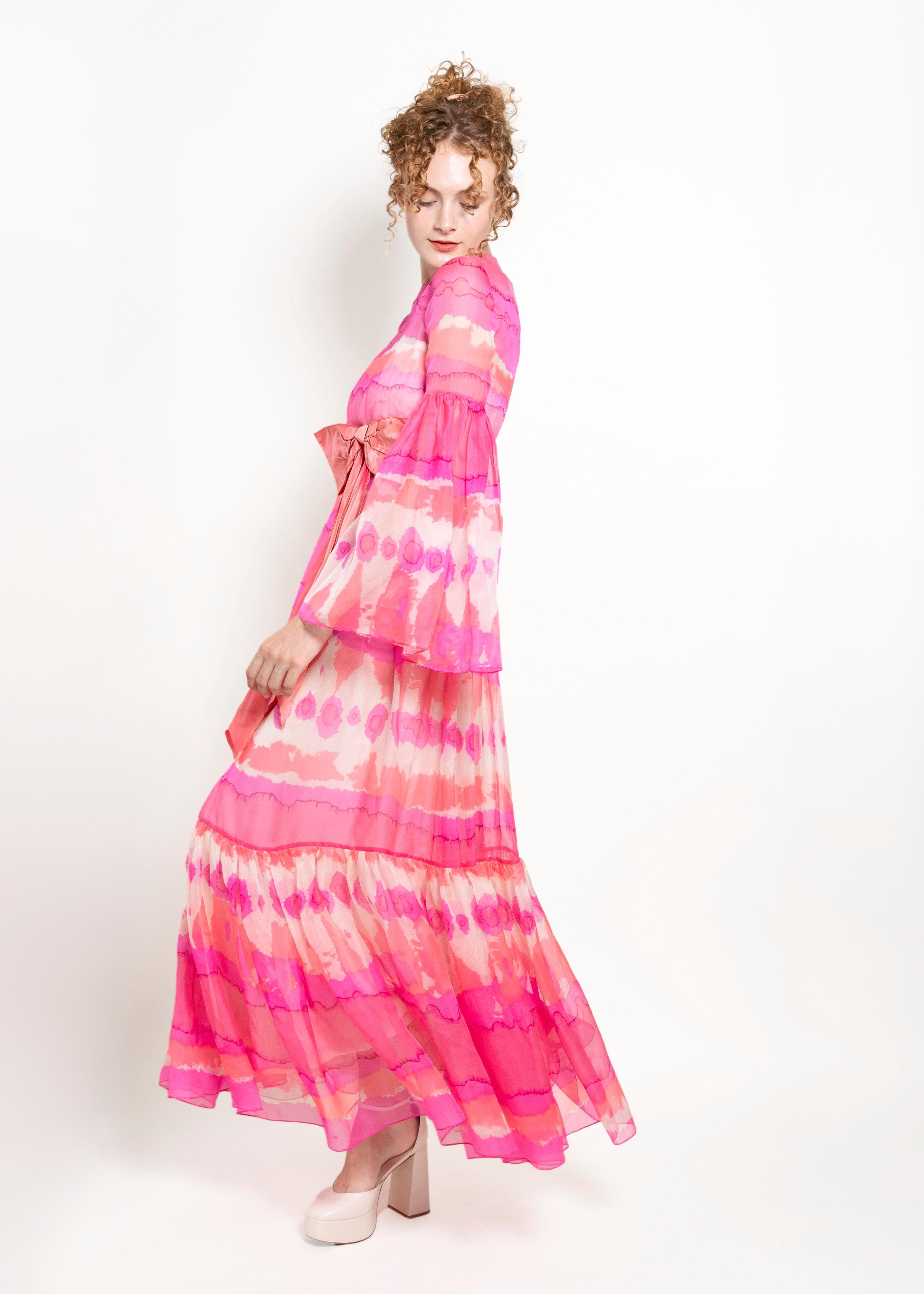 Malcolm Starr is renowned for its timeless designs, and this dress is no exception. It's a rare find that embodies the essence of the brand's vintage charm. Crafted from delicate pink chiffon, this dress exudes grace and charm. The fabric drapes