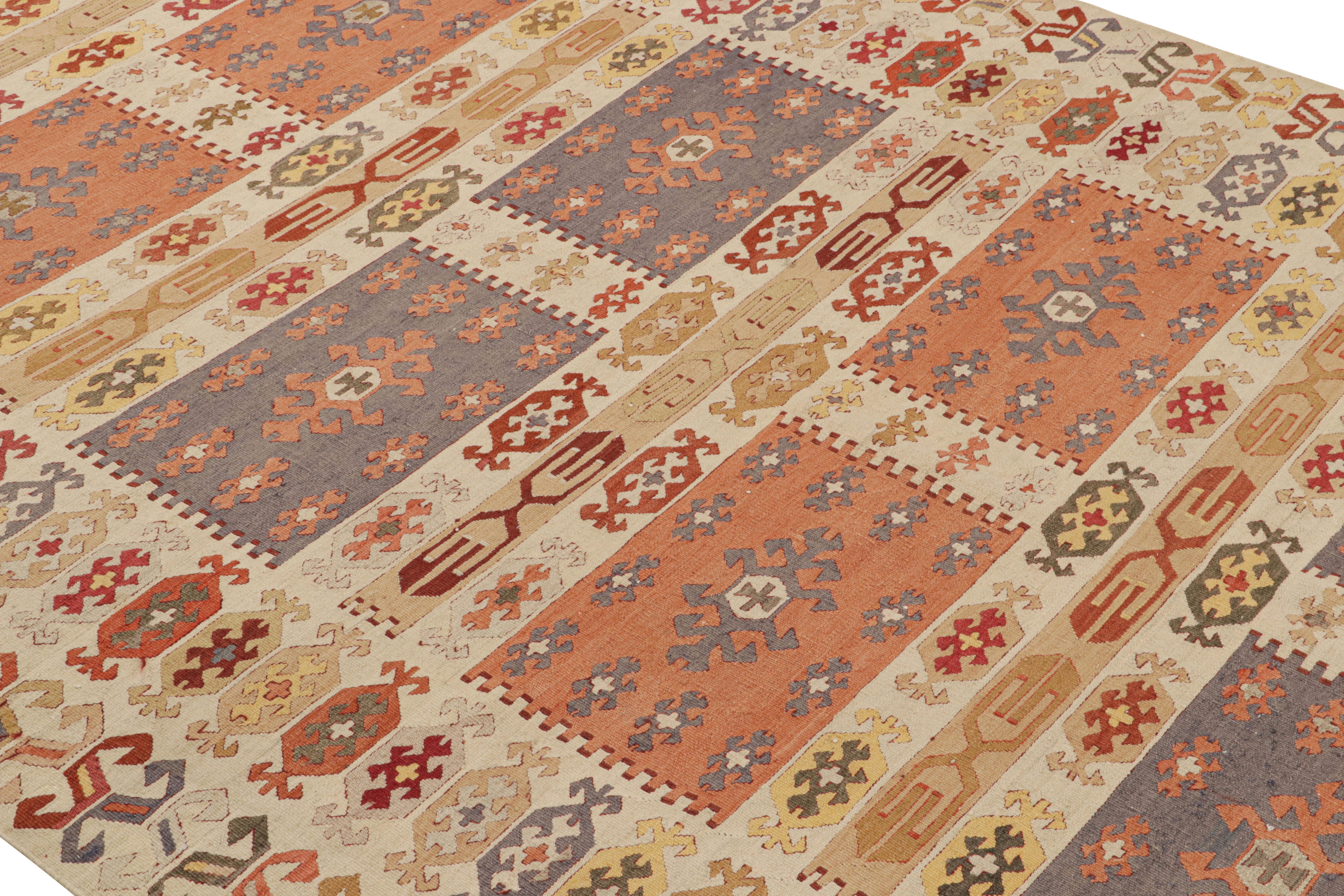 A 6 x 10 vintage Kilim rug of unique Manastire Turkish lineage, handwoven in wool, circa 1950-1960. Enjoying beige-brown hues complemented by lively tribal colorways throughout an intricate all over geometric pattern. Further in good condition for