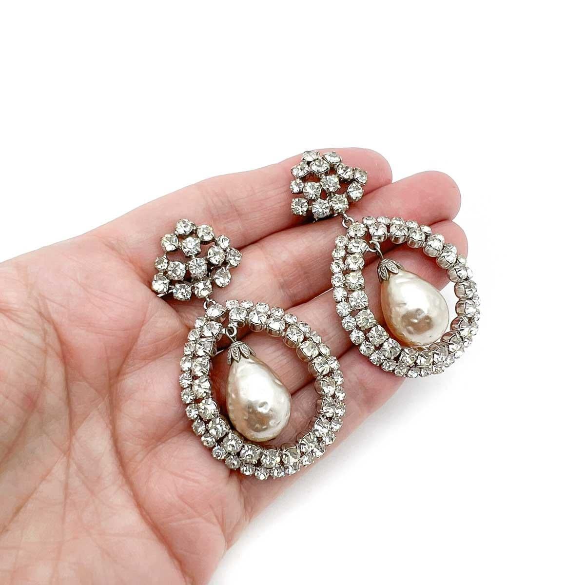 A divine pair of Vintage Manfred Kleinert Earrings. Featuring a large droplet baroque pearl framed by a glorious double row of glass crystals and suspended from a triangular top. The most elegant of designs that will shimmer as you move and add a