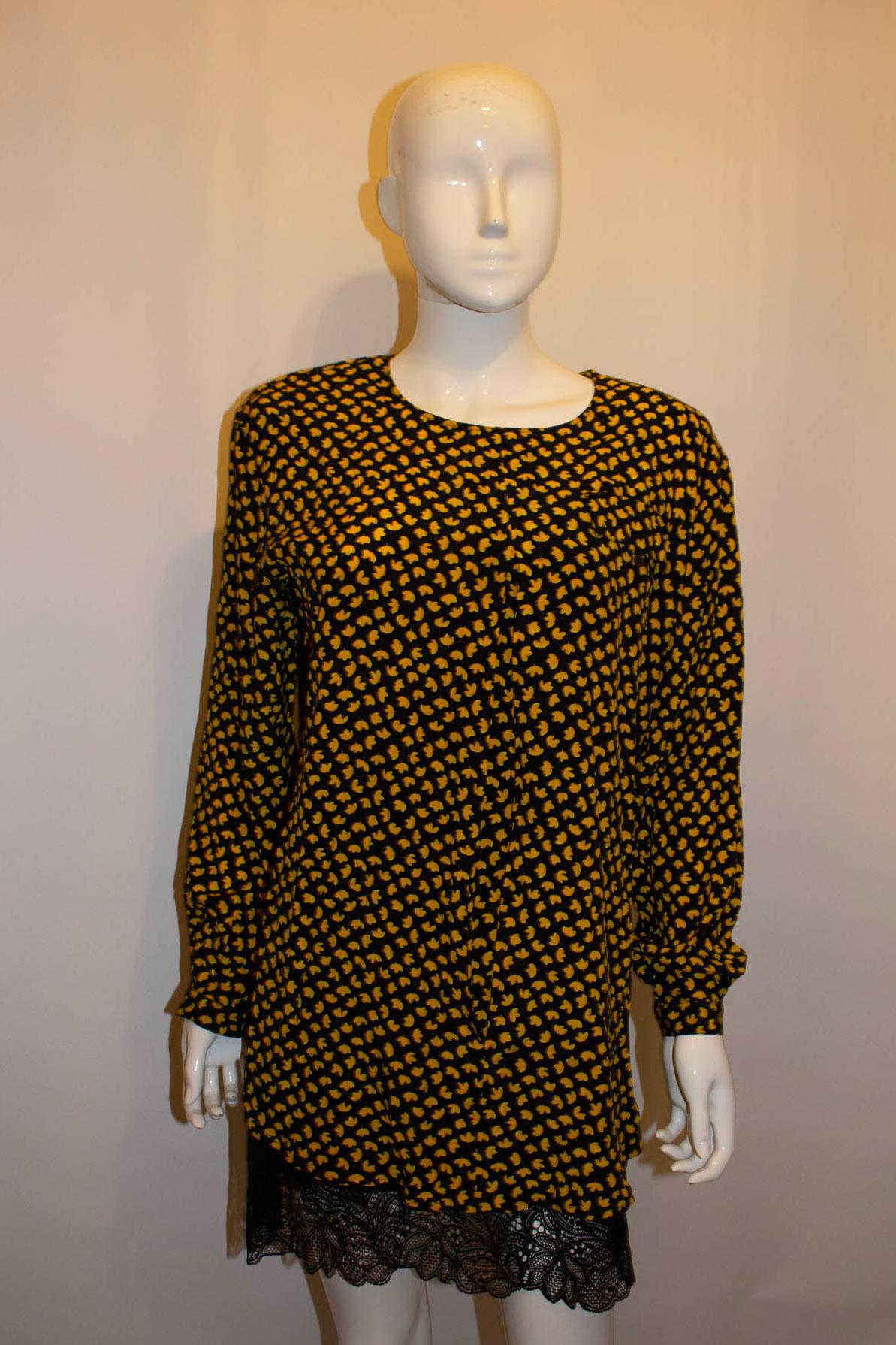 A pretty vintage silk blouse by Mani. The blouse has a black background with yellow design. It has a round neckline, pocket on the left hand side , button cuffs and pleat detail on the front. 
Size EU  Italian 40, Measurements: Bust up to 44'',