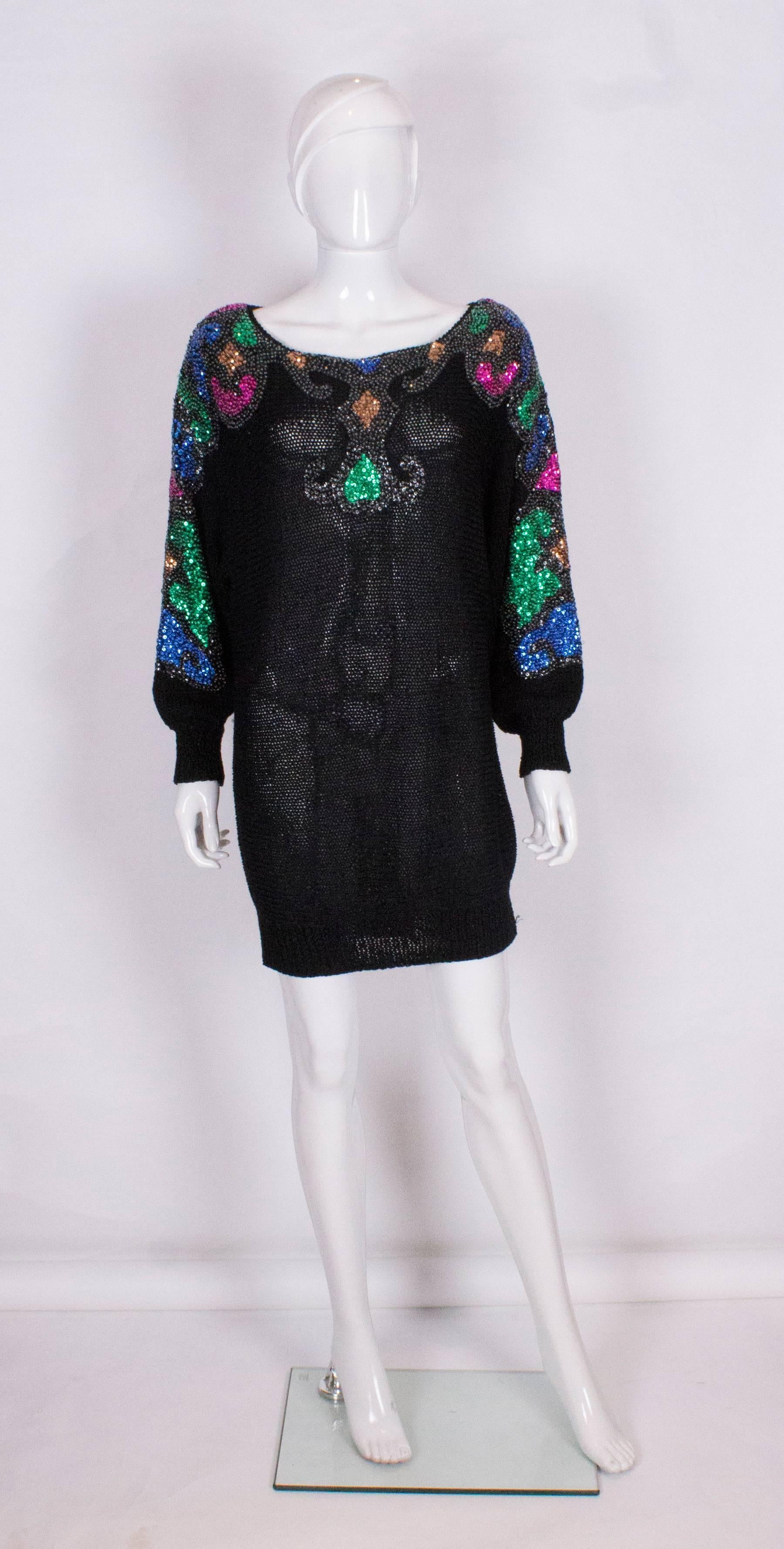 An easy to wear evening sweater by Mannell. Ideal to wear wear with leggings or an evening skirt. The jumper has a scoop neck, batwing sleeves, and embellishment  on the arms, front and back.It has the original shoulder pads.
It should be worn 