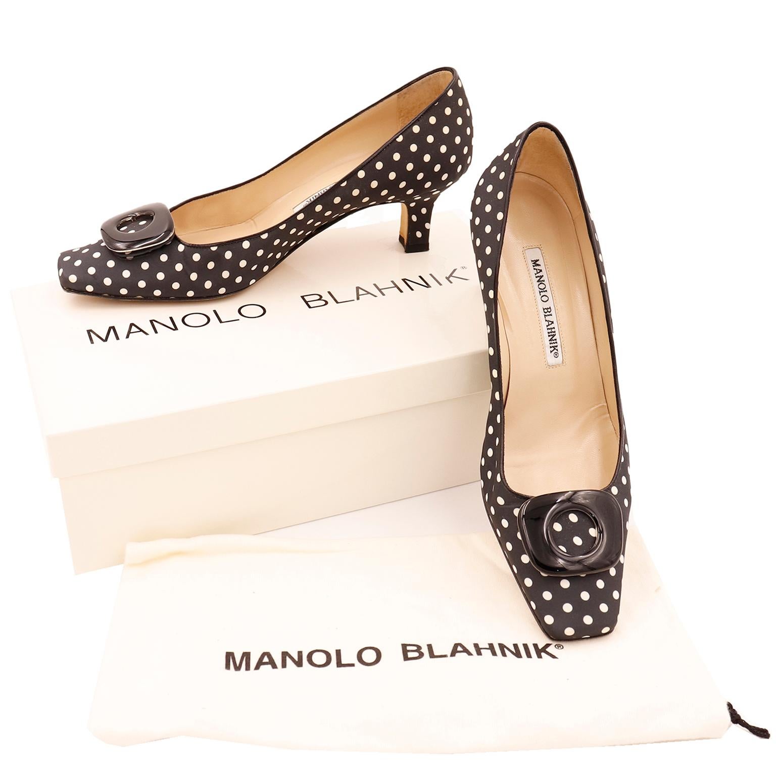 These fun Manolo Blahnik shoes are black with white polka dots. The shoes have tan insoles, leather trim and a gently squared toe. These great shoes have a low heel and attached black buckles. These come with their original box and Manolo Blahnik