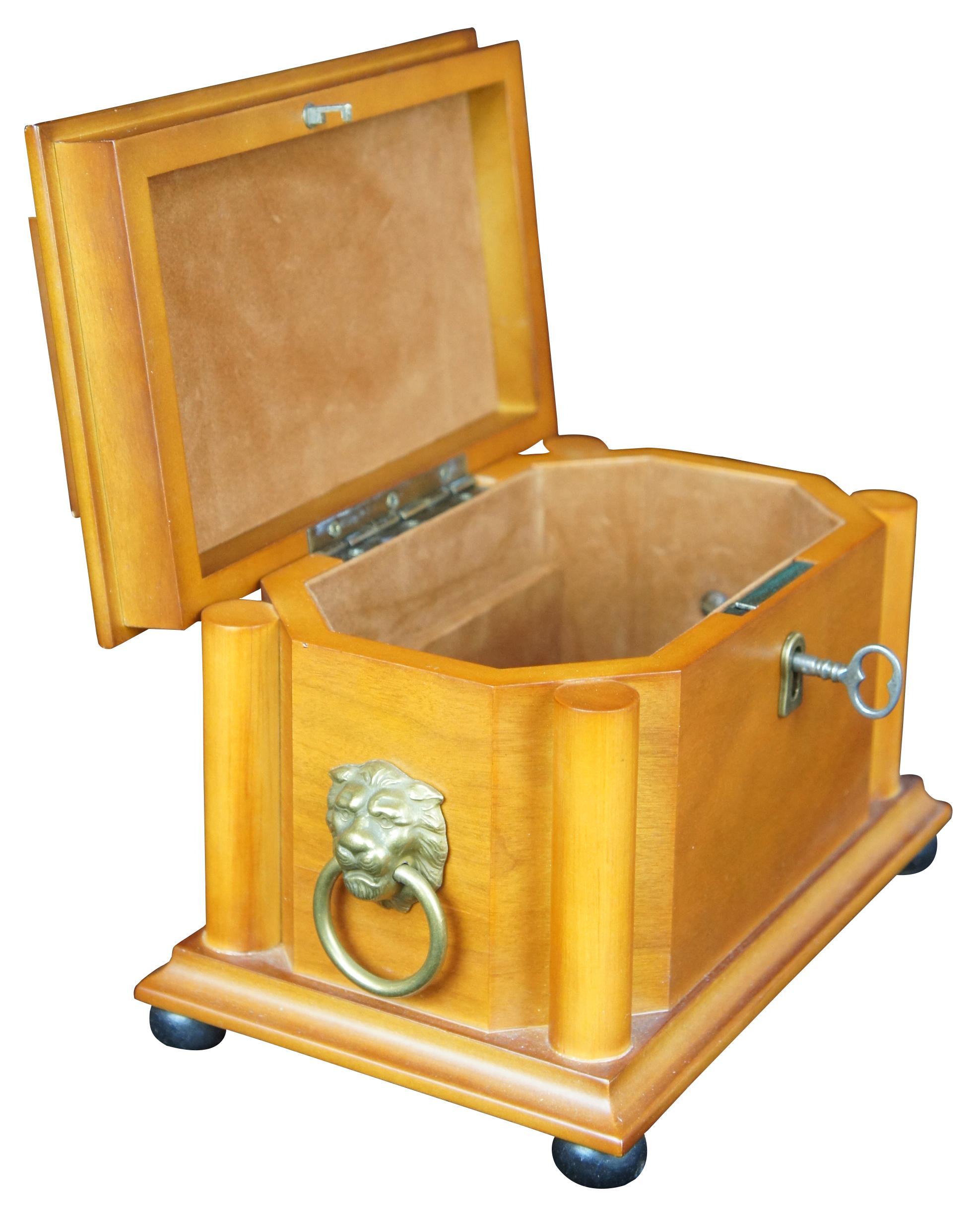 Vintage Empire/Neoclassical style keepsake valet box featuring tiered form with velvet lining, corinthian columns, lion head handles, footed base, and lock & key.
 