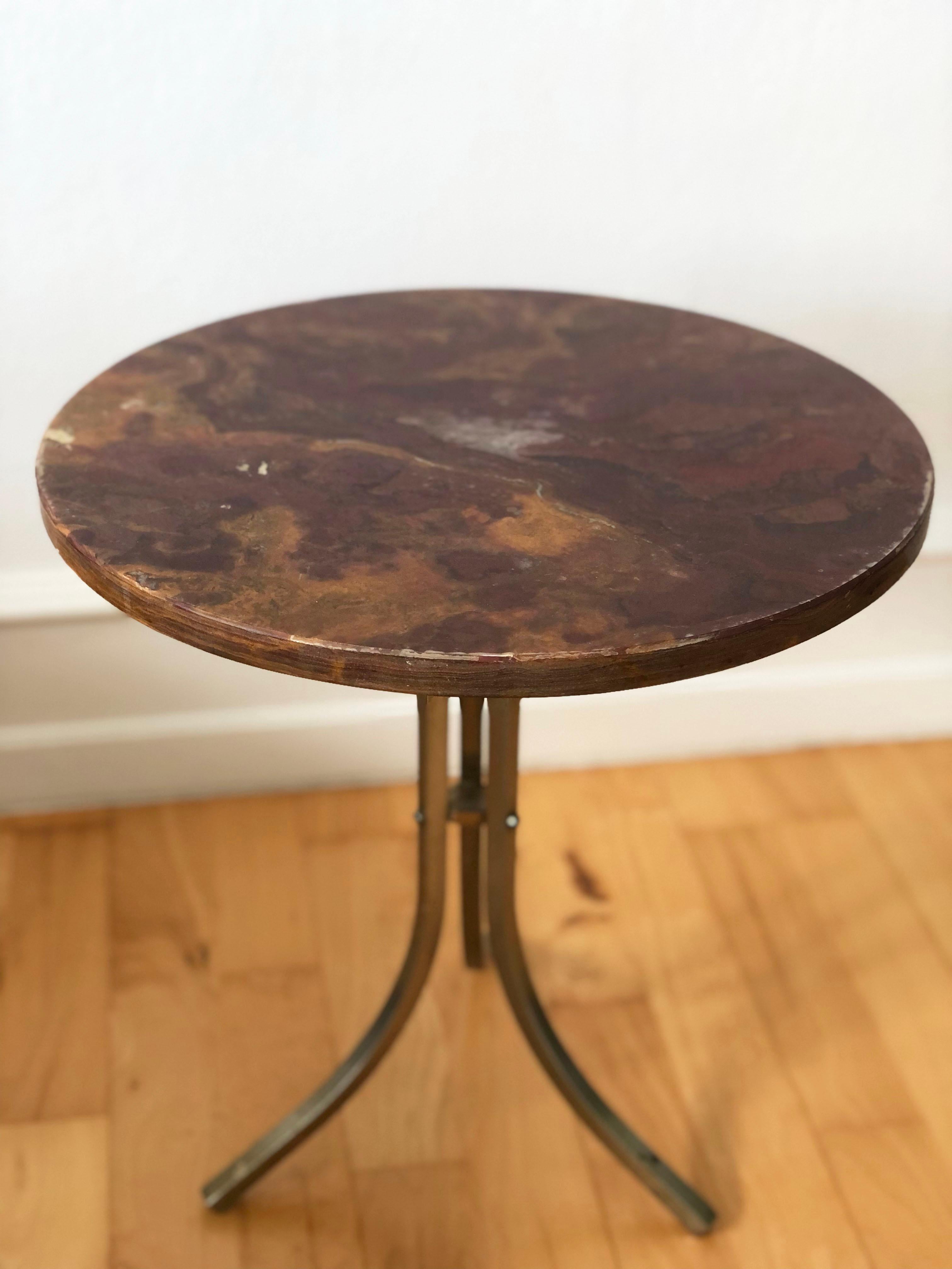 Elegant mid-century side table featuring a round Rosa Levanto marble top with warm red, gold, and cream veining. The solid brass base has a natural aged patina, adding character and authenticity. A refined piece ideal as a plant stand, accent table,
