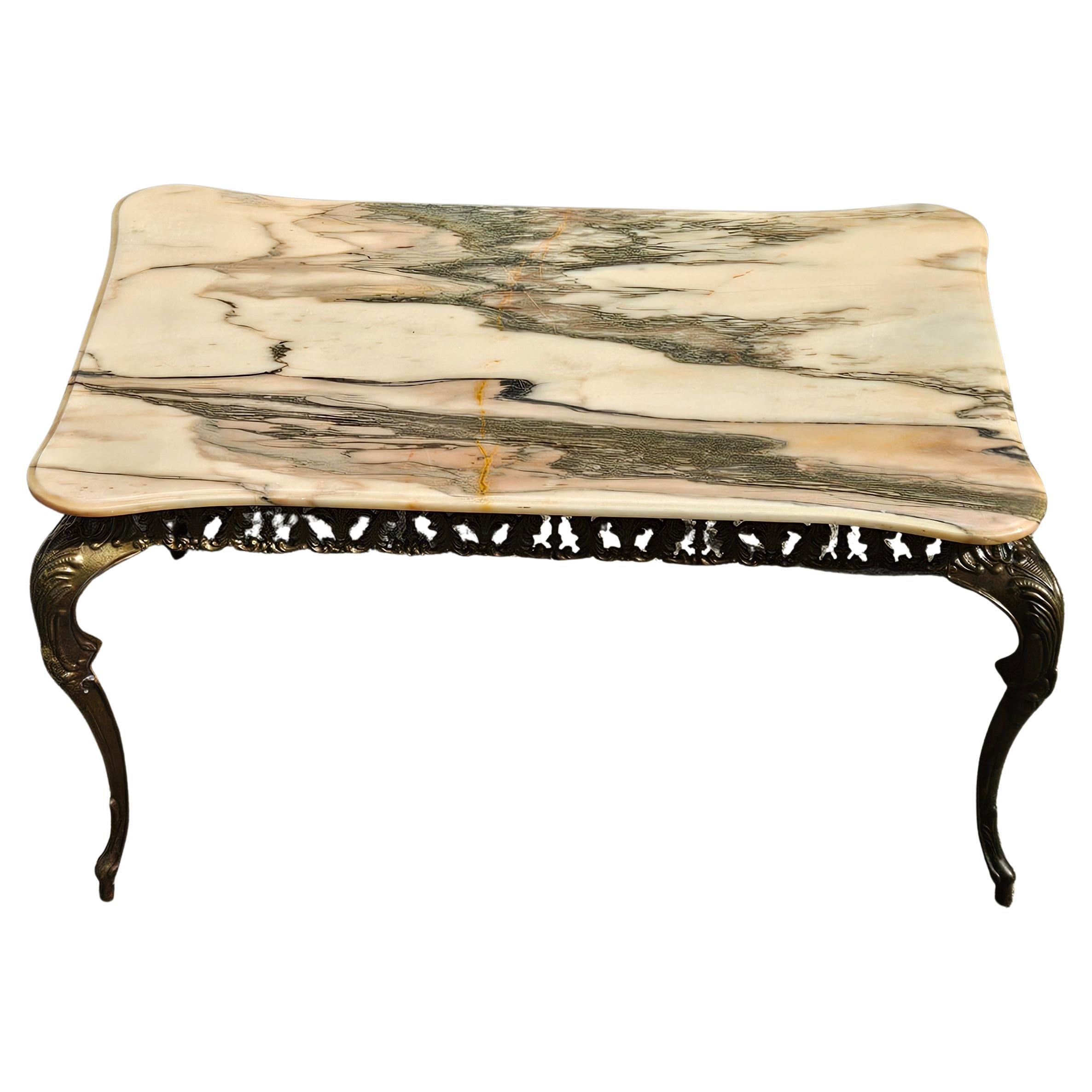 French Vintage Marble Coffee Table with an Antique Bronze Frame - Cocktail Table from the 60s
Exquisite Marble Table top from the 60s with natural Patterns and delicate Veins in soft shades of vanilla, anthracite, rose and a hint of orange. Rounded
