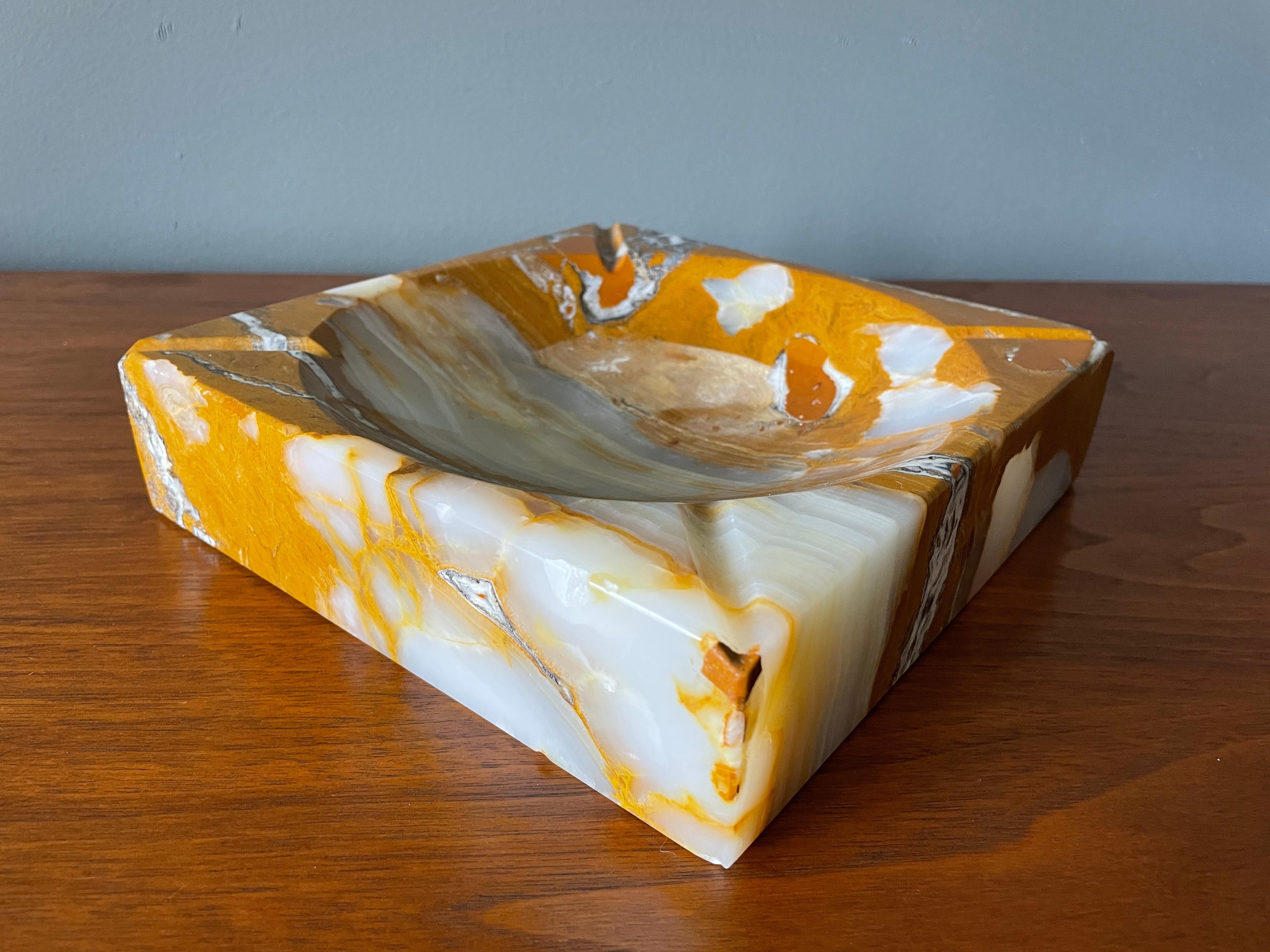 Vintage marble ashtray manufactured by Peter Pepper Products, circa 1970s. Very thick and heavy with a beautiful vein pattern. Highly polished with beveled edges.