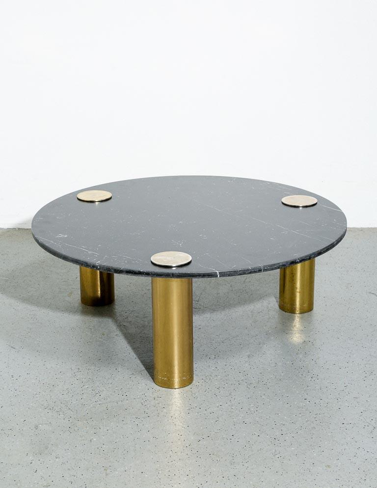 Vintage coffee table in nero marquina marble with stumpy tubular brass legs. Attributed to Pace, 1970s.