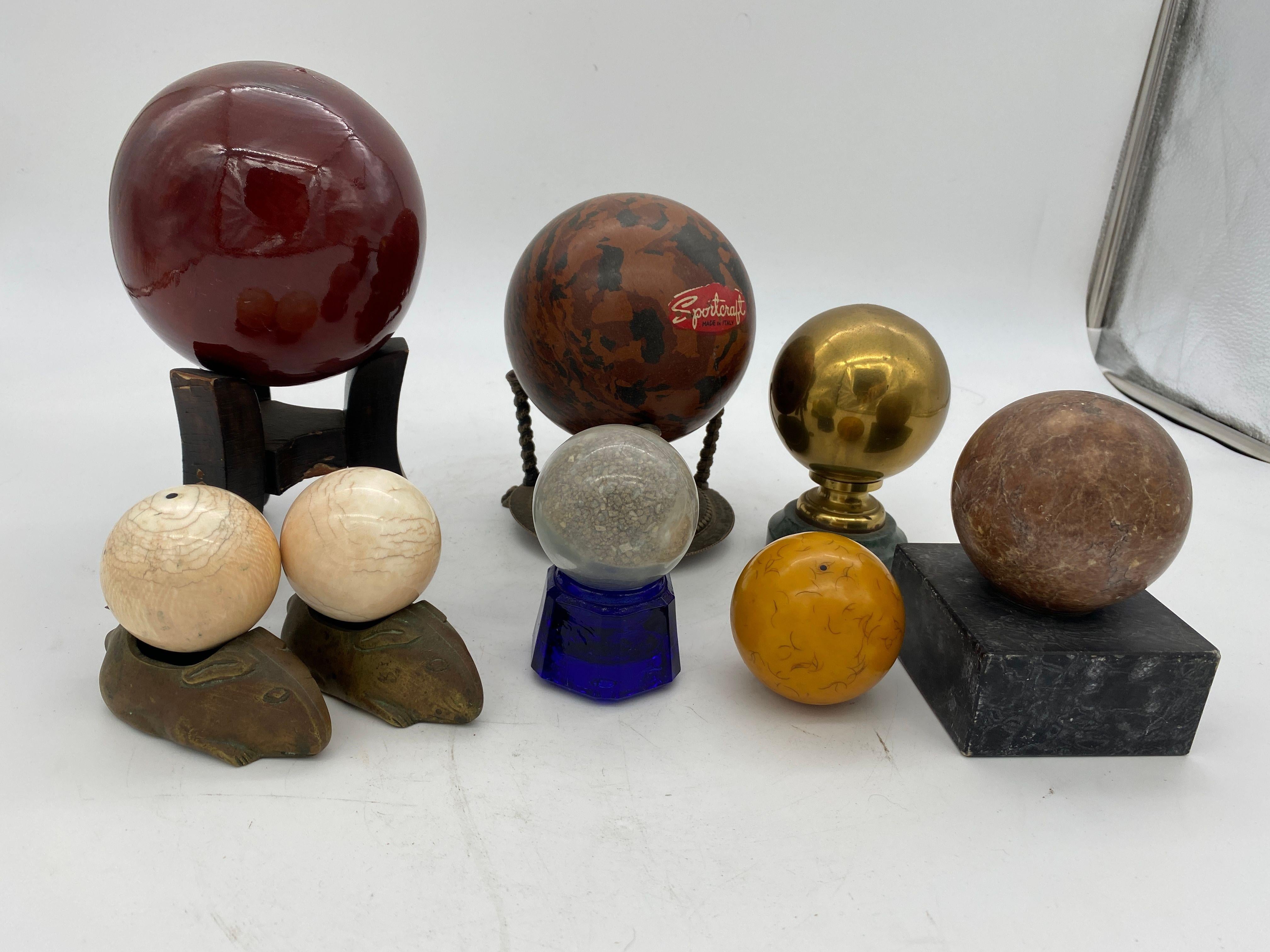Collection of 8 Spheres featuring 4 in marble and stone, 2 resin, 1 Ceramic and one in brass. Seven come with bases.

The largest is 8