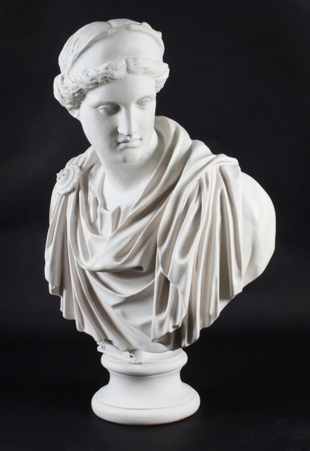 A vintage beautifully sculpted marble bust of a Roman Goddess Diana in a toga on elegant pedestal in the form of a classical ancient Greek Doric column, late 20th century in date.

After the full size Roman marble copy which was after the ancient
