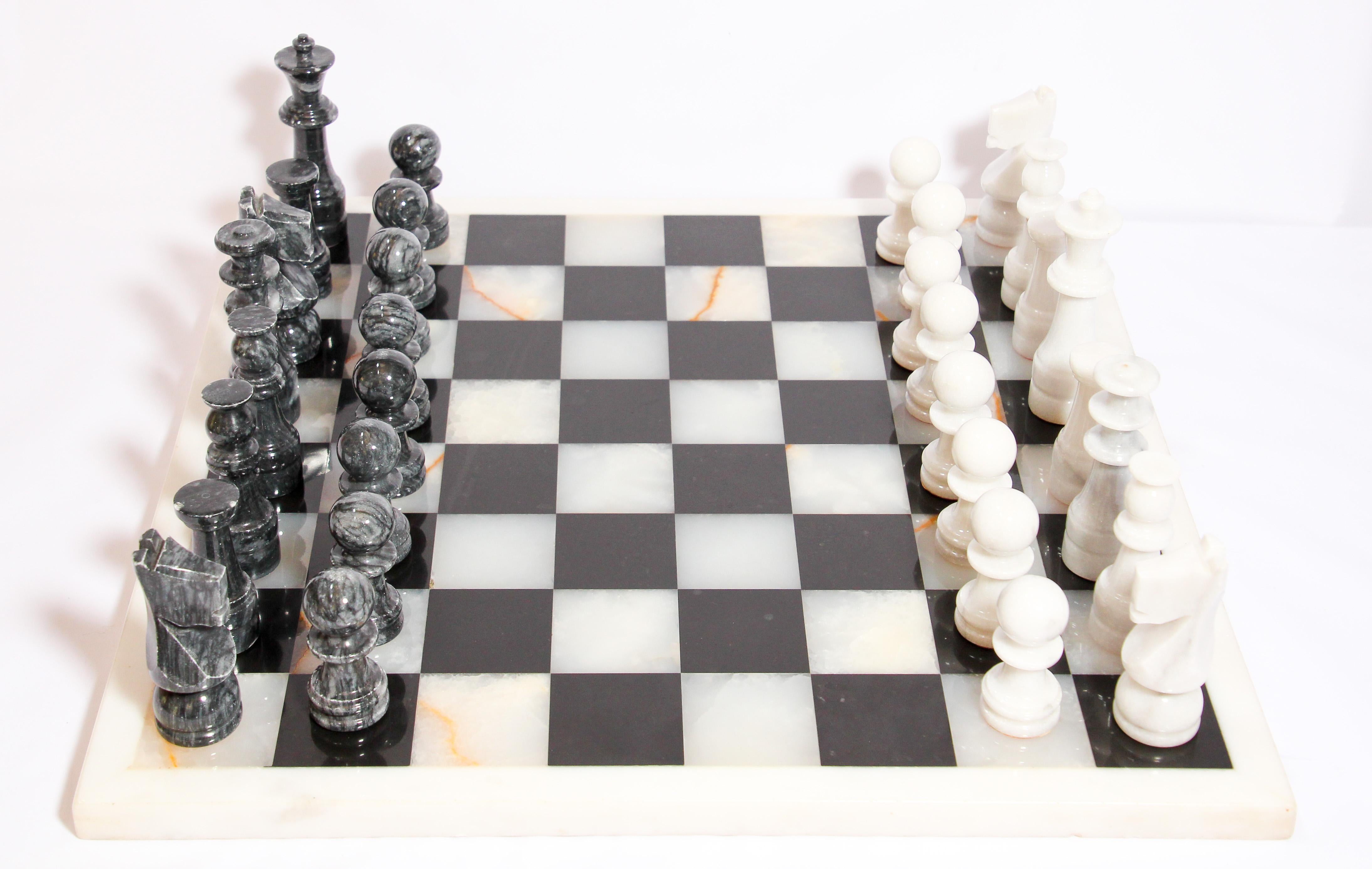 Vintage large heavy marble chess set complete board in white and black with chess set with elaborately onyx hand carved chess pieces with fine decoration.
Measures: The king stands 4.5” tall, smaller pieces are 2