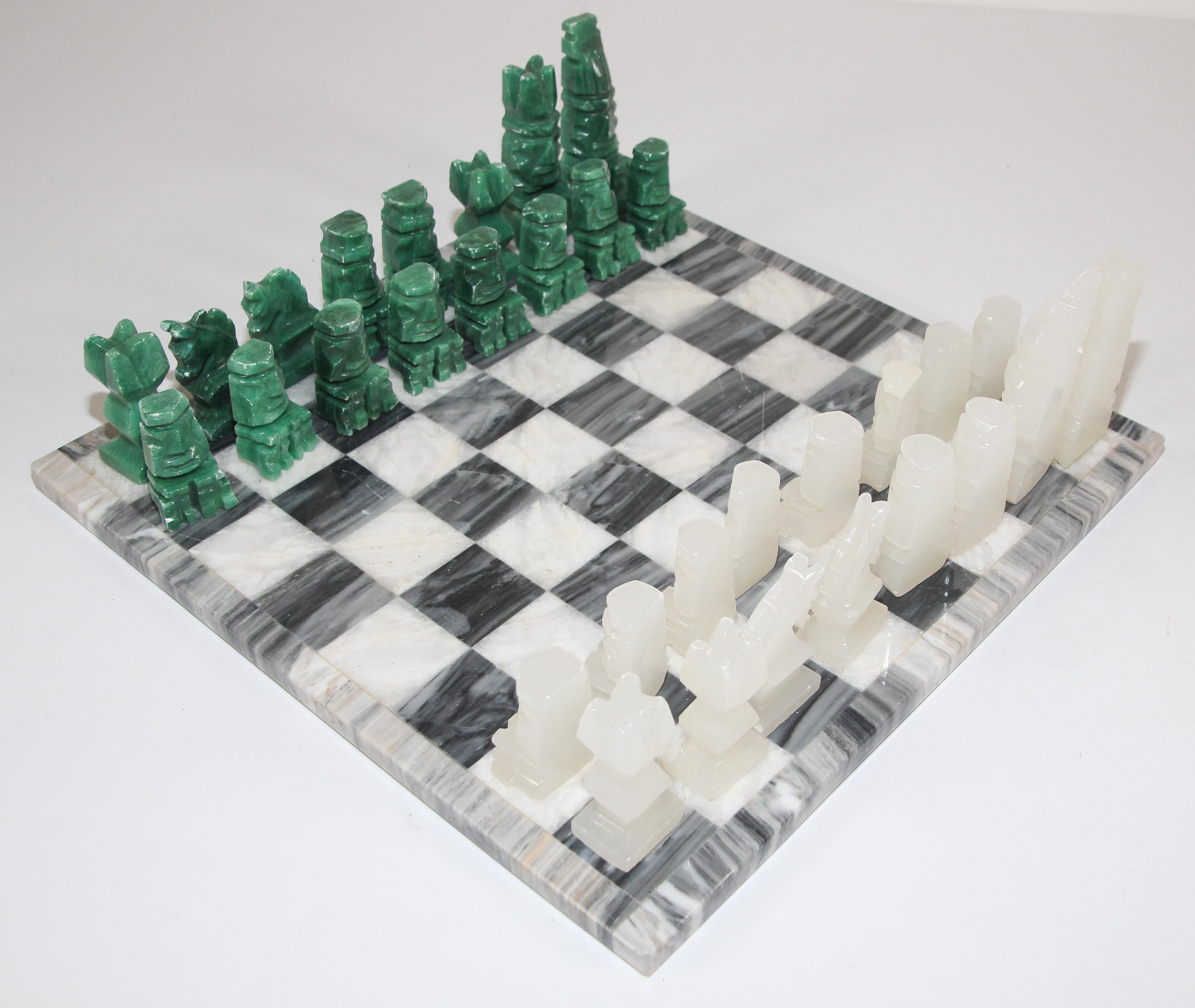Vintage large heavy marble chess set complete board in white and black with chess set with elaborately onyx hand carved chess pieces.
Complete green malachite and white marble stone chessboard with game pieces. 
Hand-carved from three different