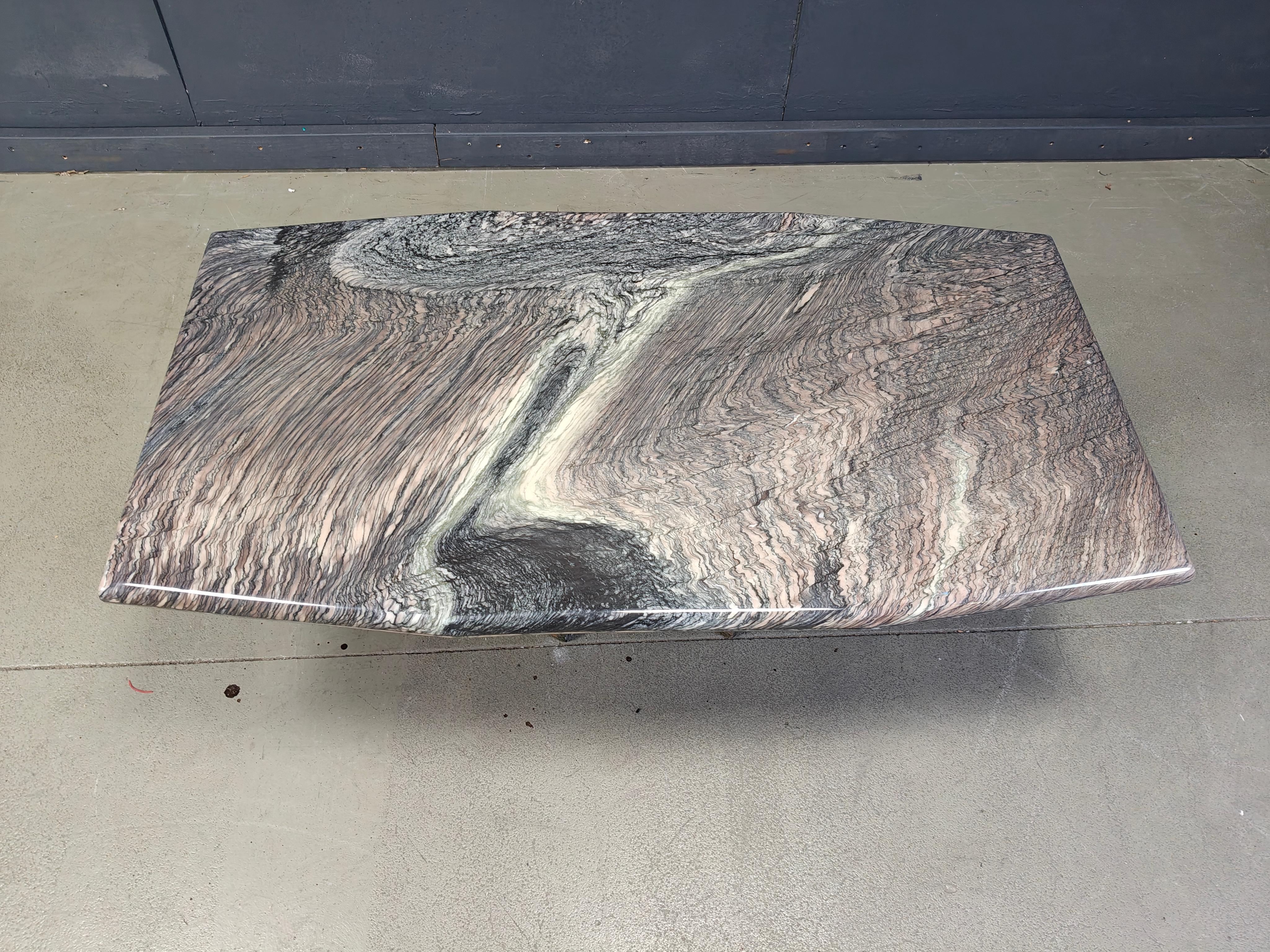 Staggering marble coffee table with the most beautiful natural vaining we've ever seen on any table.

A mixture of green, grey and beige tints create a fantastic looking table.

beautiful base.

1970s - Italy 

Height: 40cm
Width: 125cm
Depth:
