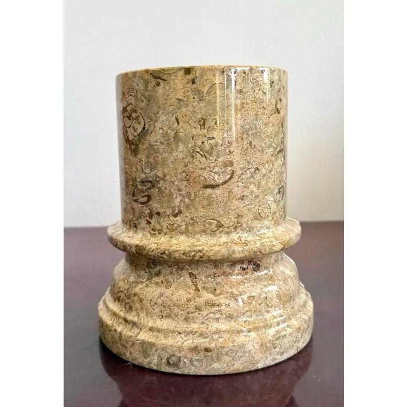 A substantial set of vintage bookends carved from solid marble in the form of classical architectural columns. The surface features rich natural veining and fossil-like inclusions, adding texture and visual interest to the smooth, polished finish.