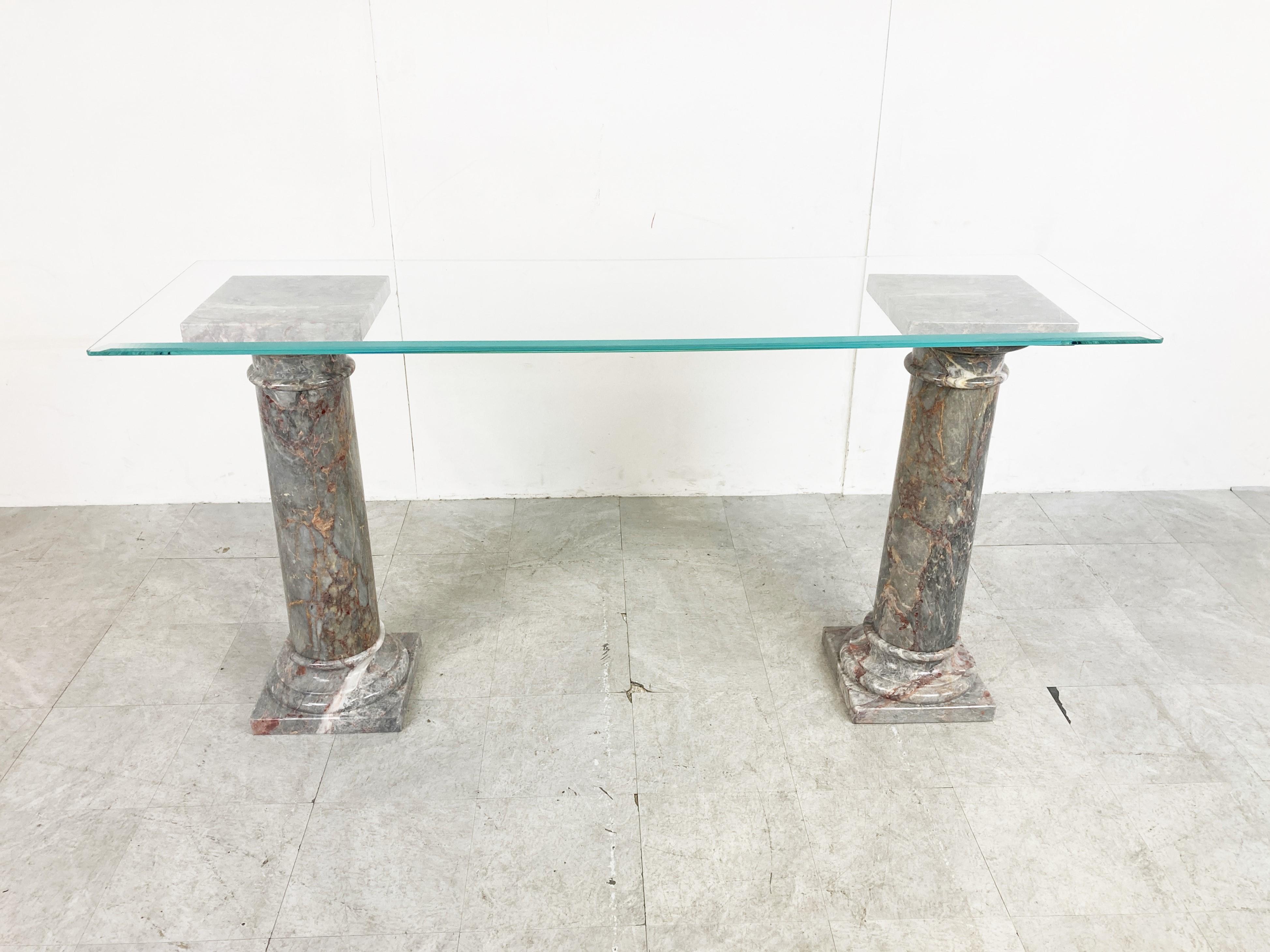 Beautiful console table consisting of two grey marble columns and a clear glass top.

The marble columns come in three pieces for easier transport.

The glass can be customized uppon request.

Beautiful natural veining in the marble.

very