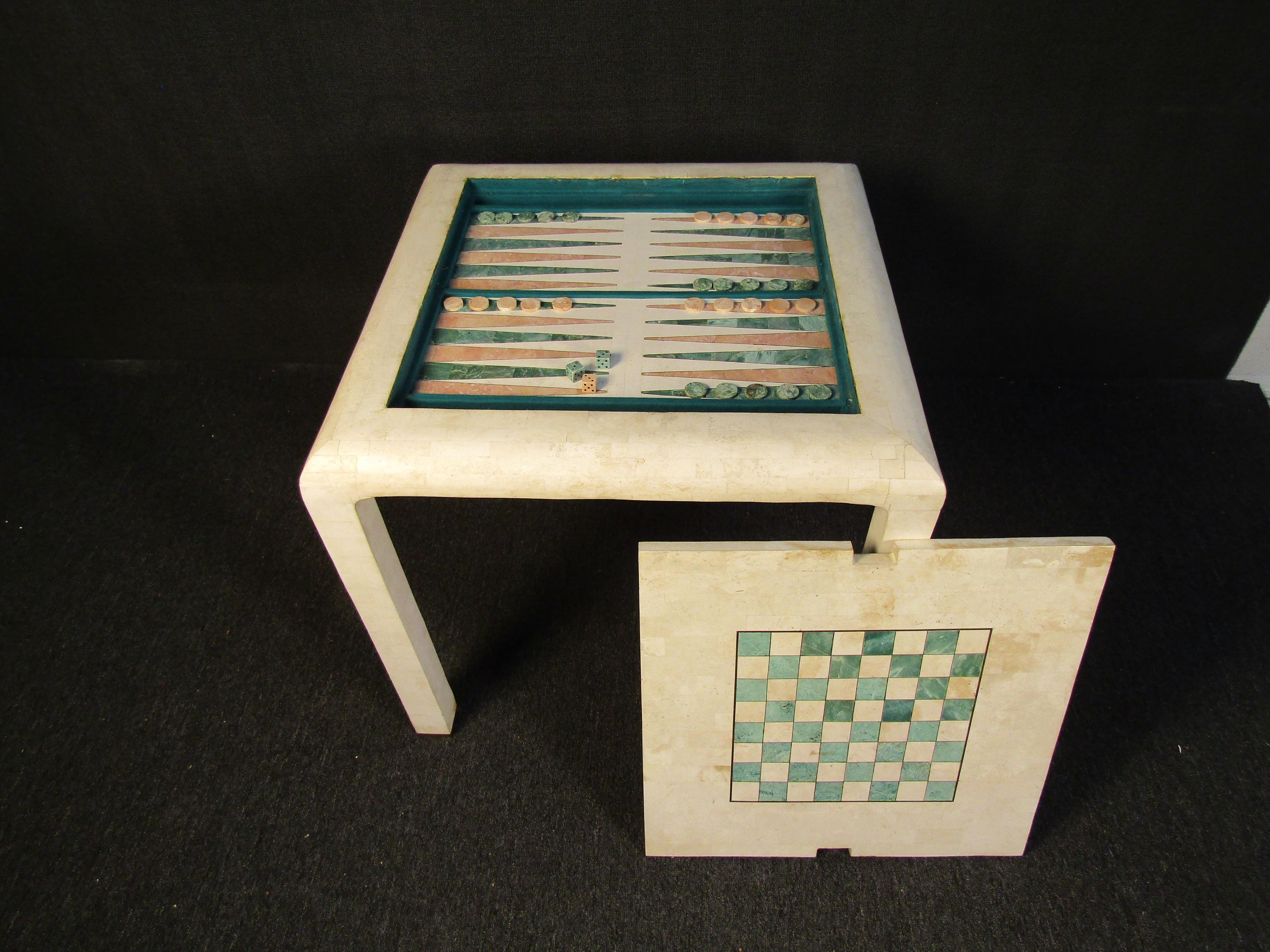 A unique and rare game table in tessellated marble, this Mid-Century Modern piece is styled after the designs of Karl Springer. A removable top is perfect for checkers or chess, while underneath a backgammon board with components is revealed. Please