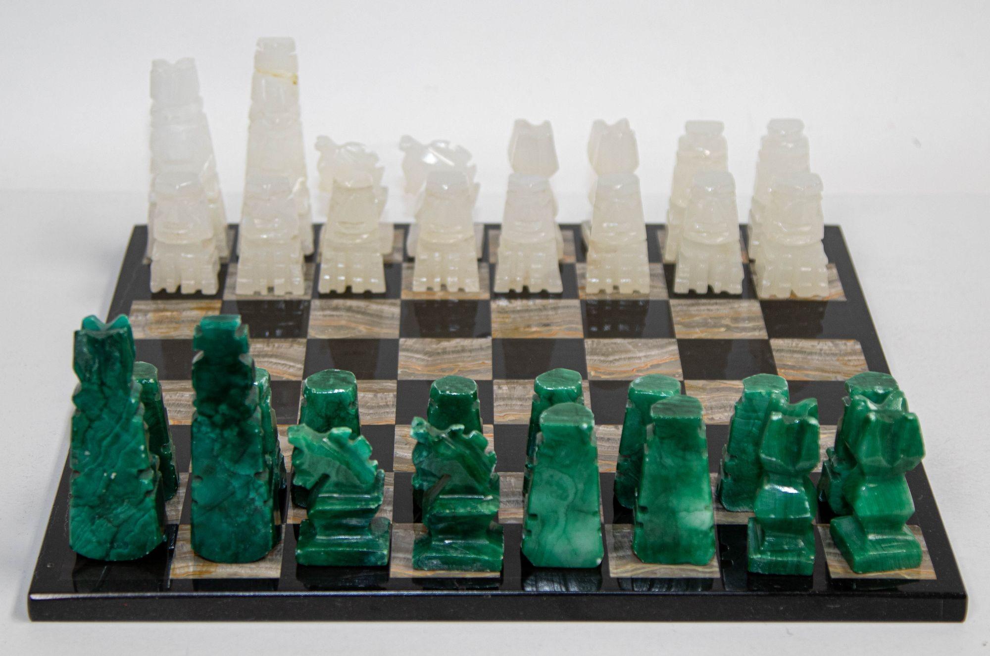 Vintage marble large chess set with hand-carved green onyx pieces.
Vintage mid 20th century Mexican stone marble chess set complete chess board in brown and black marble stone with elaborately hand carved green and white chess pieces.
The stone