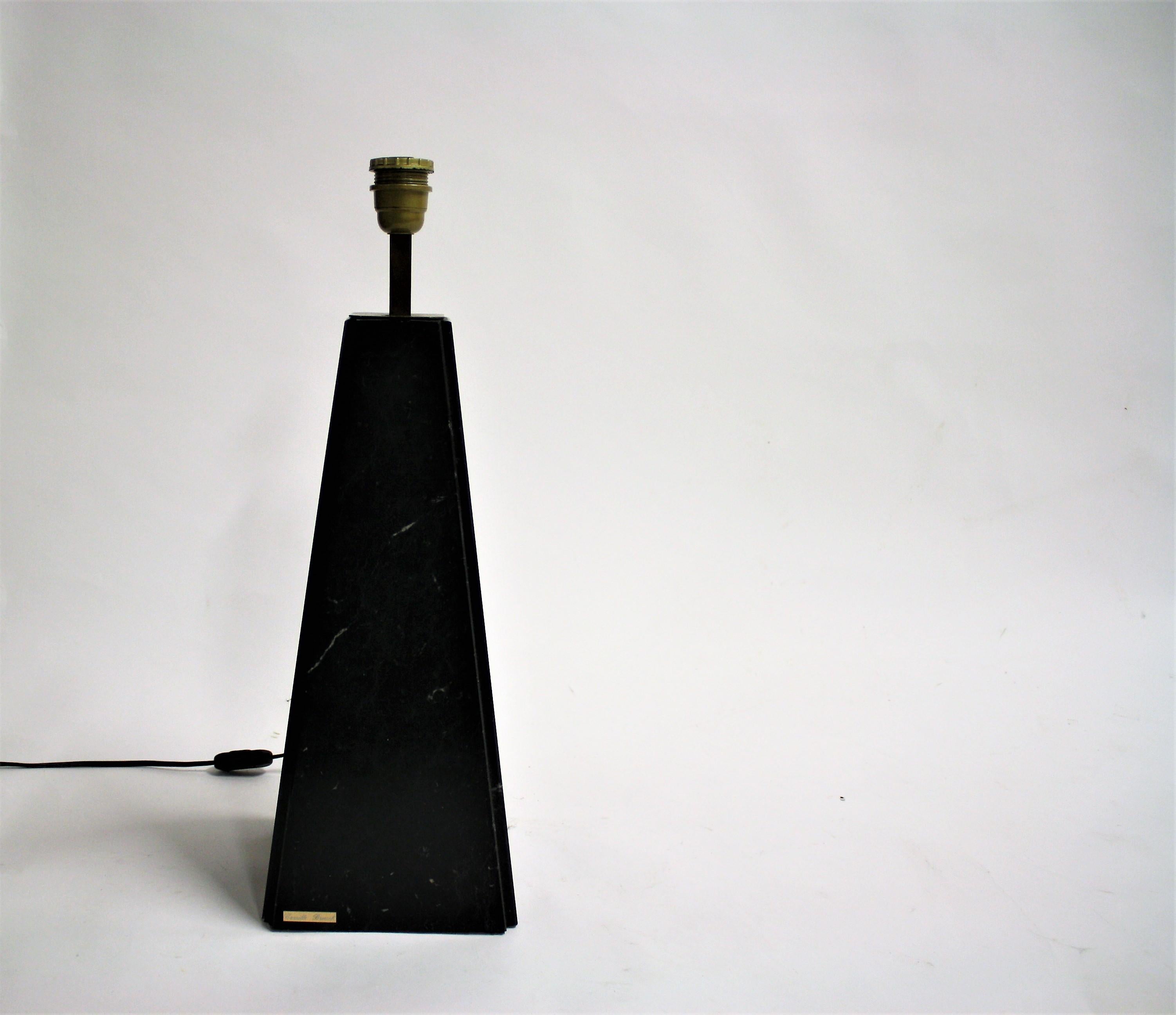 Large black marble table lamp with brass.

The lamp was designed and manufactured by Belgian artisan Camille Breesch.

Rewired, tested and ready for use with a regular E26/E27 light bulb.

Original lamp shade included, although showing some