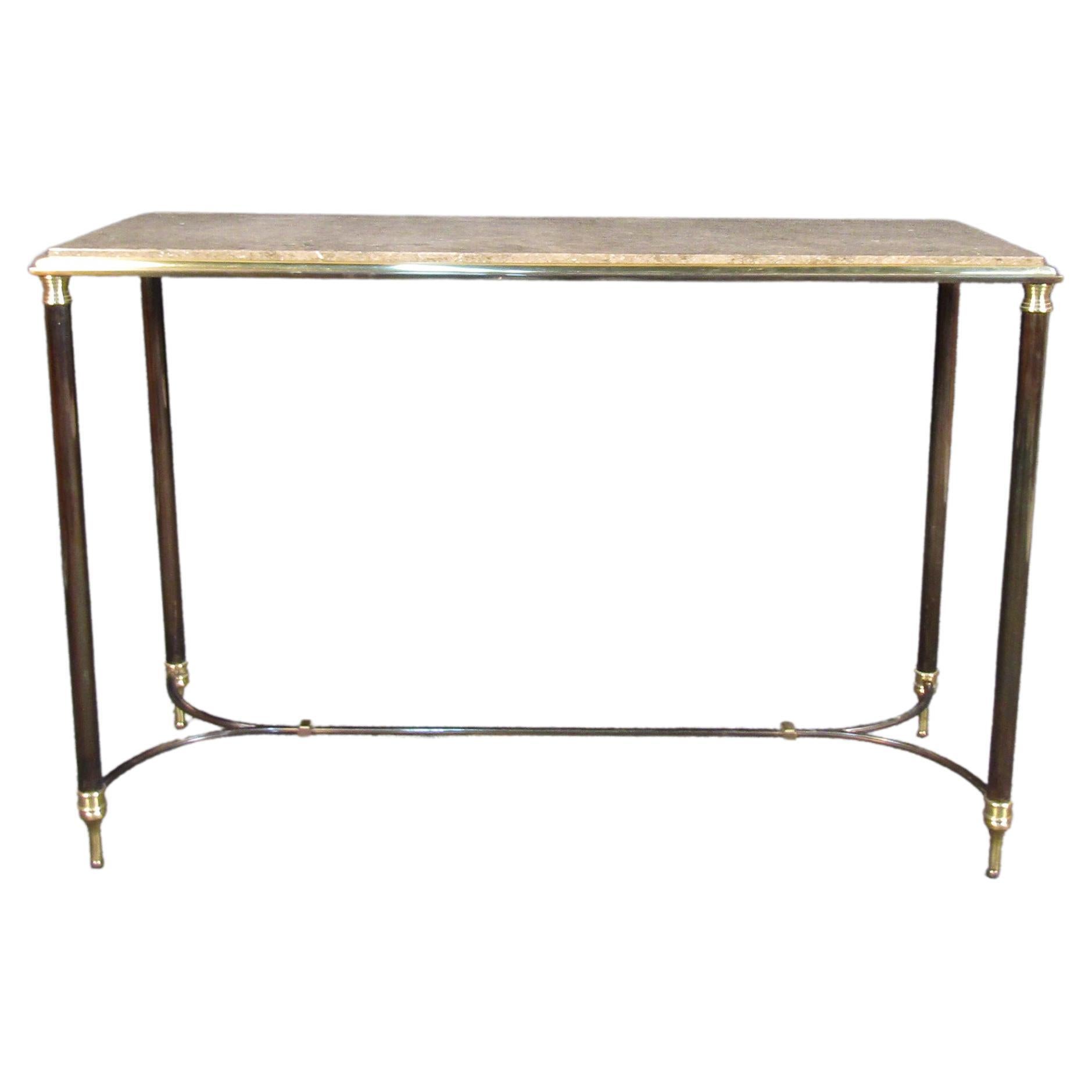 Vintage metal and marble console Table. This table features ornate metal frame, legs and accenting. The beautiful beveled edge leading up to the marble surface top is an eye catching feature that would compliment any space it is put in. 
Please
