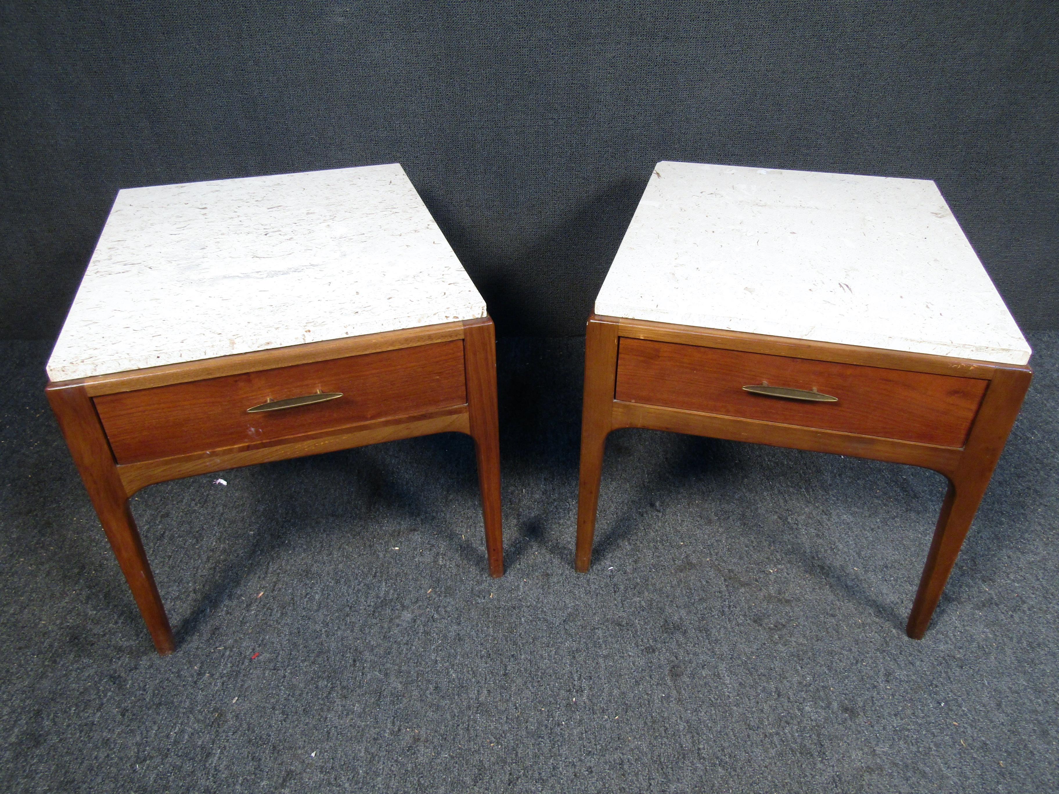This pair of vintage Lane nightstands features Rectangular marble tops and a sleek walnut construction with one drawer per piece. These nightstands will make a great addition to your living or office space. Please confirm item location (NJ or NY).