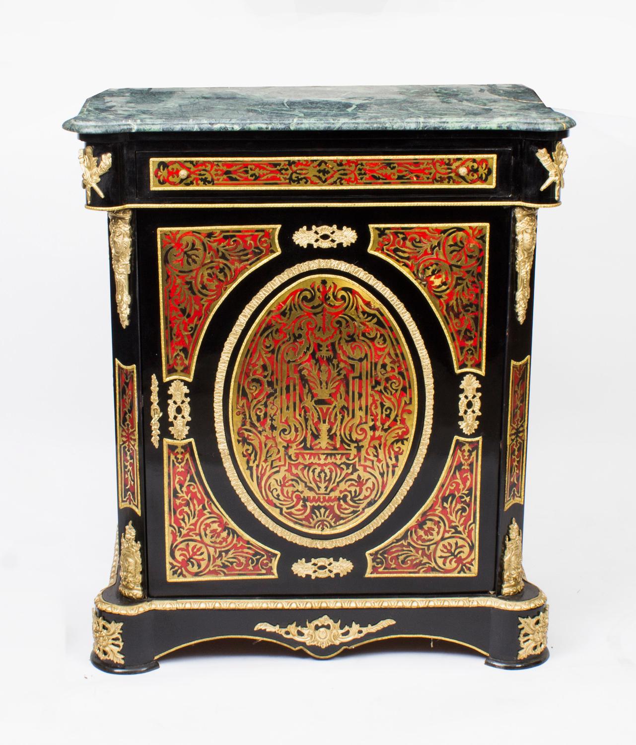 This is a stunning vintage Louis XVI style Boulle pier cabinet dating from the late 20th century.

This ornate cabinet is ebonised and decorated with cut brass inlaid Boulle with exquisite ormolu mounts and has a beautiful 