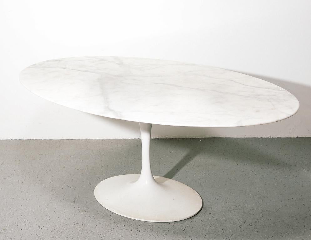 Vintage tulip style dining table after Eero Saarinen for Knoll. Elliptical marble top with cast aluminum pedestal base.