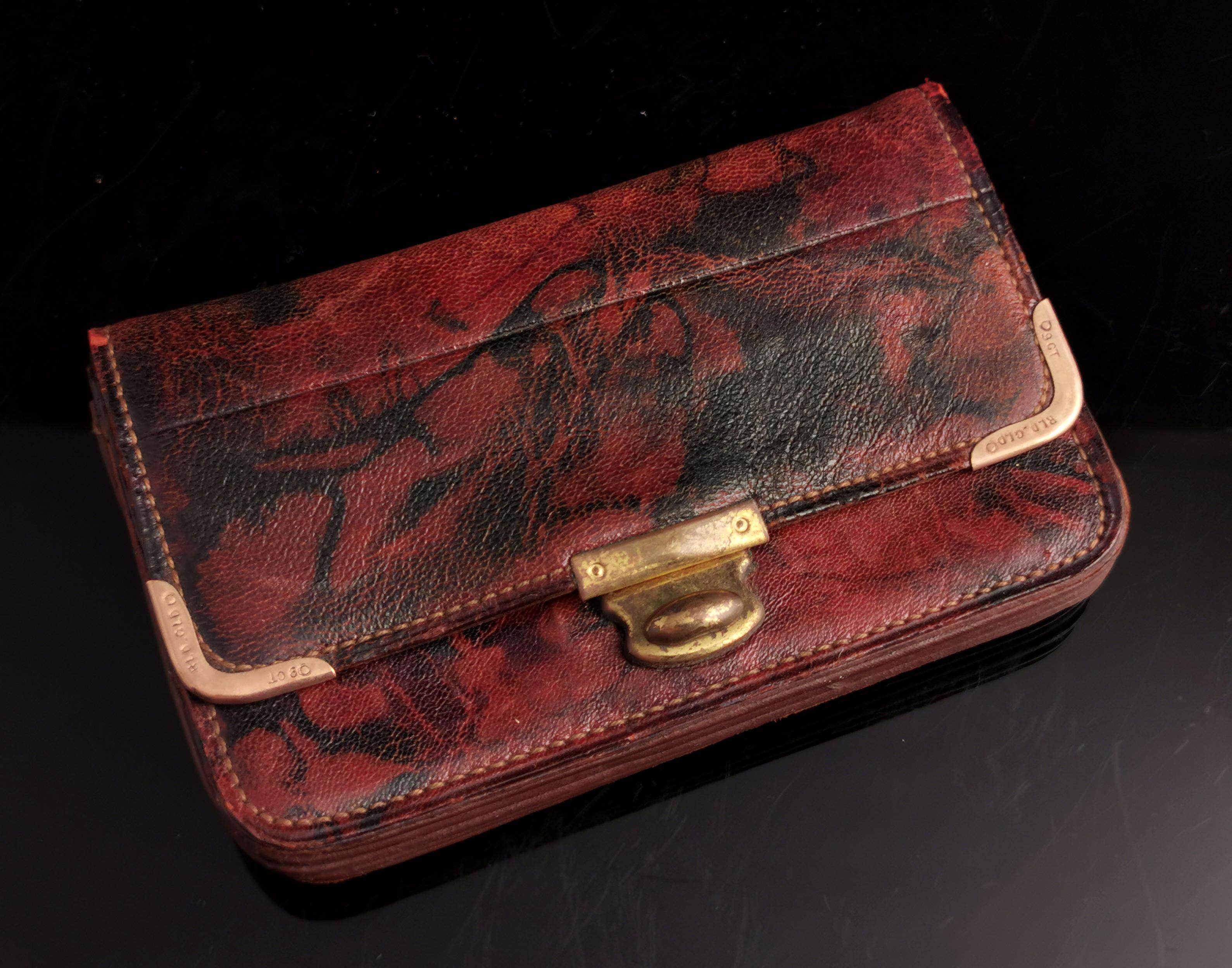 A seriously stylish vintage c1940s marbled leather purse or wallet.

Attractive red / marbled, super soft Persian leather with 9ct Rolled gold corners and a brass push clasp.

Internally it has multiple compartments with gilt lettering, old