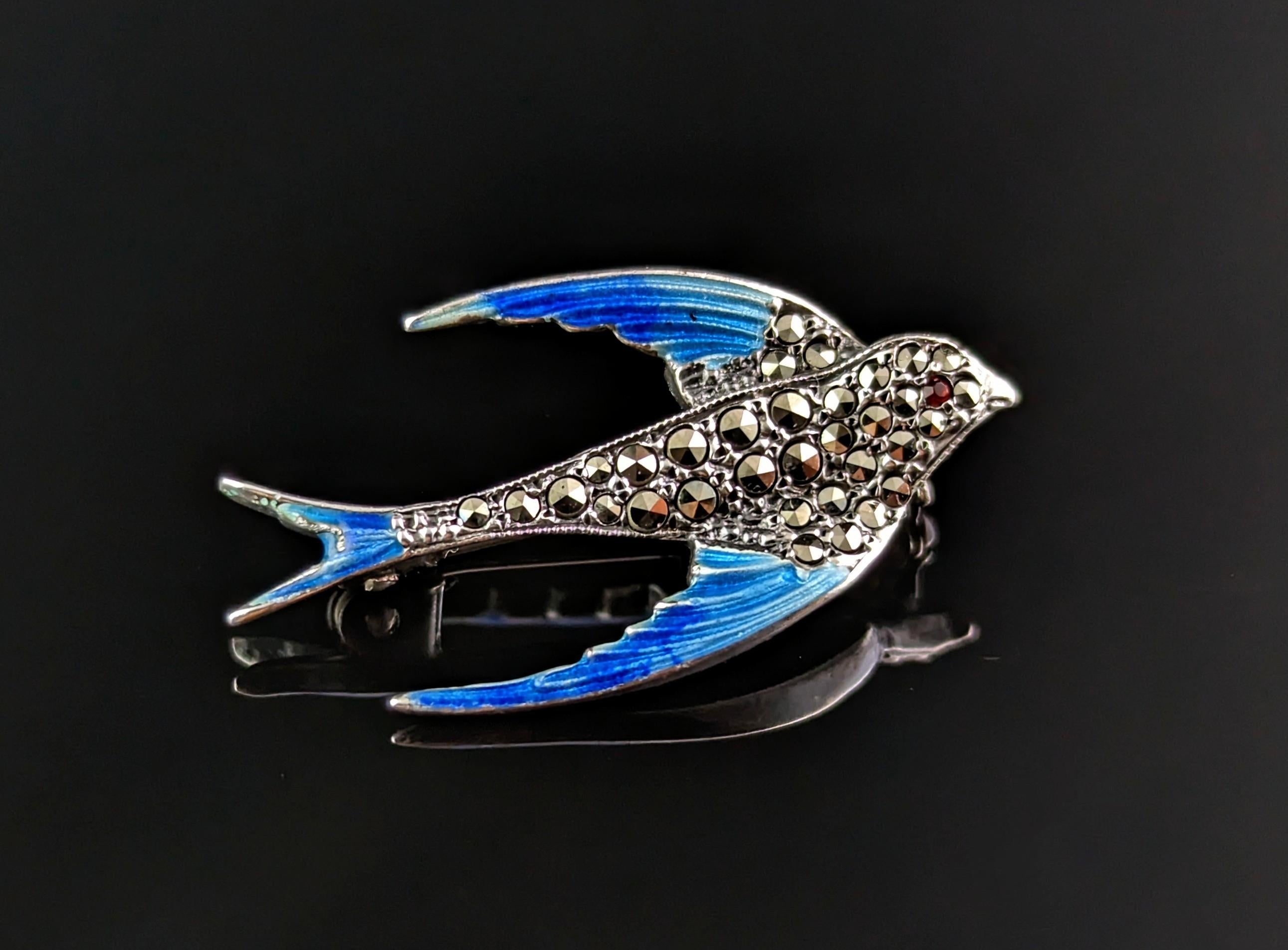 A charming vintage mid century era c1940s silver, Marcasite and enamel swallow brooch.

This is a small sized brooch well modelled as a swallow in 800 silver, adorned with marcasite and decorated in beautiful blue enamel.

The bird has a tiny red