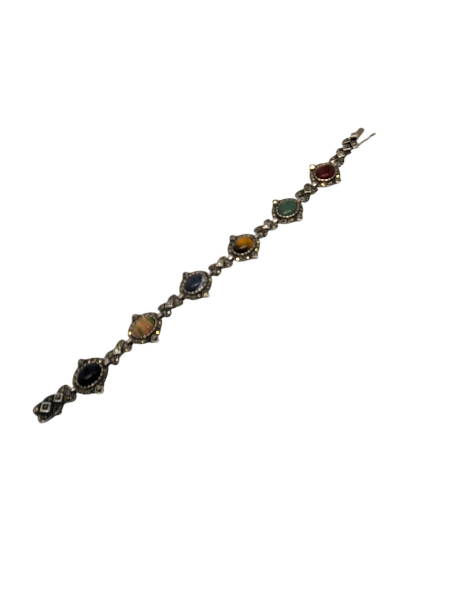 Vintage Sterling Silver Carved Gemstone Scarab Bracelet.

This vintage marcasite bracelet circa 1980 features 6 hand carved gemstones scarabs consisting of Onyx ,Bloodstone ,Lapis Lazuli, Tigers Eye, Chrysoberyl & Carnelian with Marcasite accent